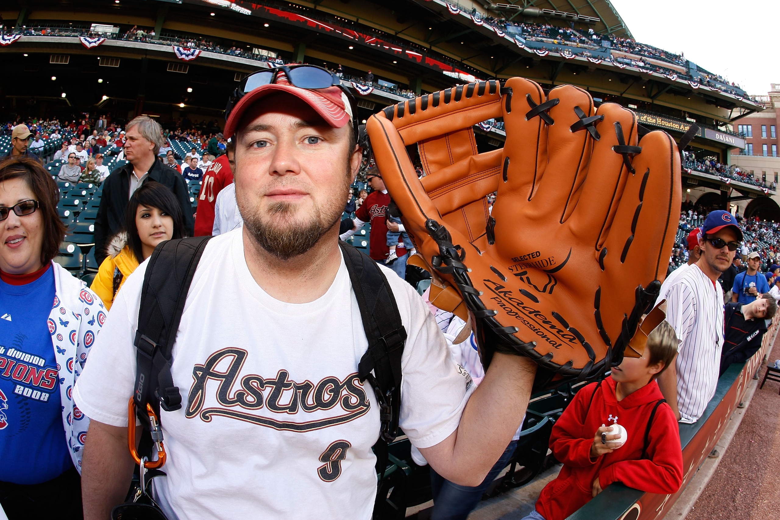 HOUSTON - APRIL 06:  A fan holds up a giant baseball glove before a game between the Chicago Cubs and the Houston Astros on Opening Day on April 6, 2009 at Minute Maid Park in Houston, Texas.  (Photo by Chris Graythen/Getty Images)