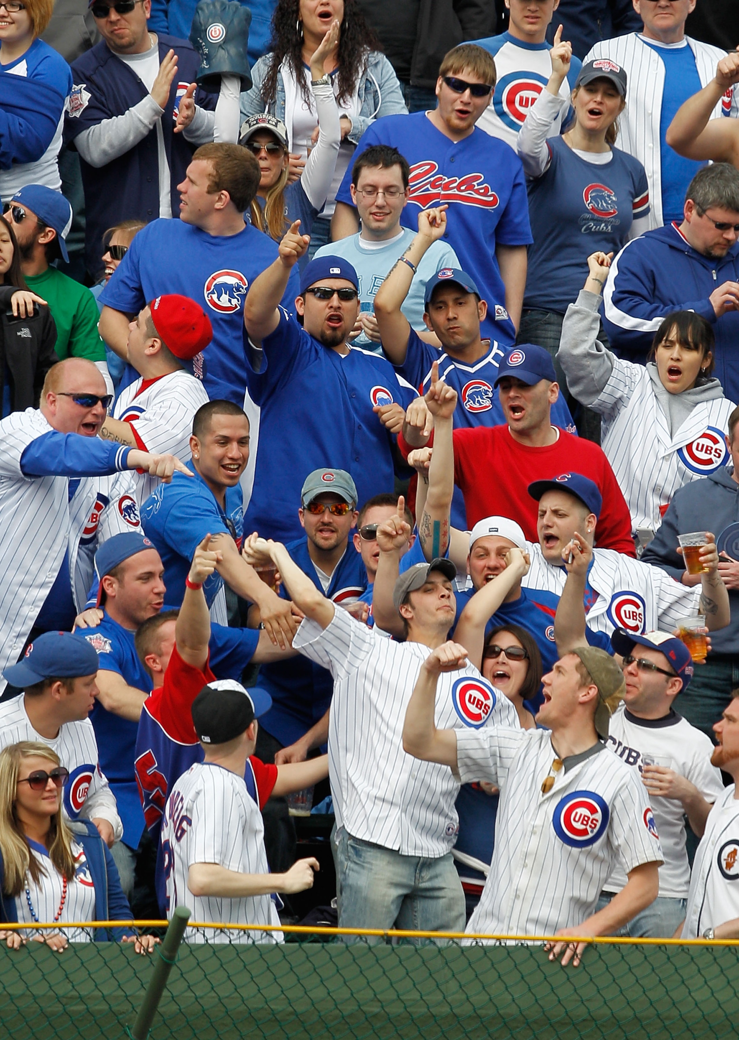 CHICAGO - APRIL 12: Chicago Cub fans in the right field bleachers encourage another fan to throw a home run ball hit by Ryan Braun of the Milwaukee Brewers back onto the field on Opening Day at Wrigley Field on April 12, 2010 in Chicago, Illinois. The Cub