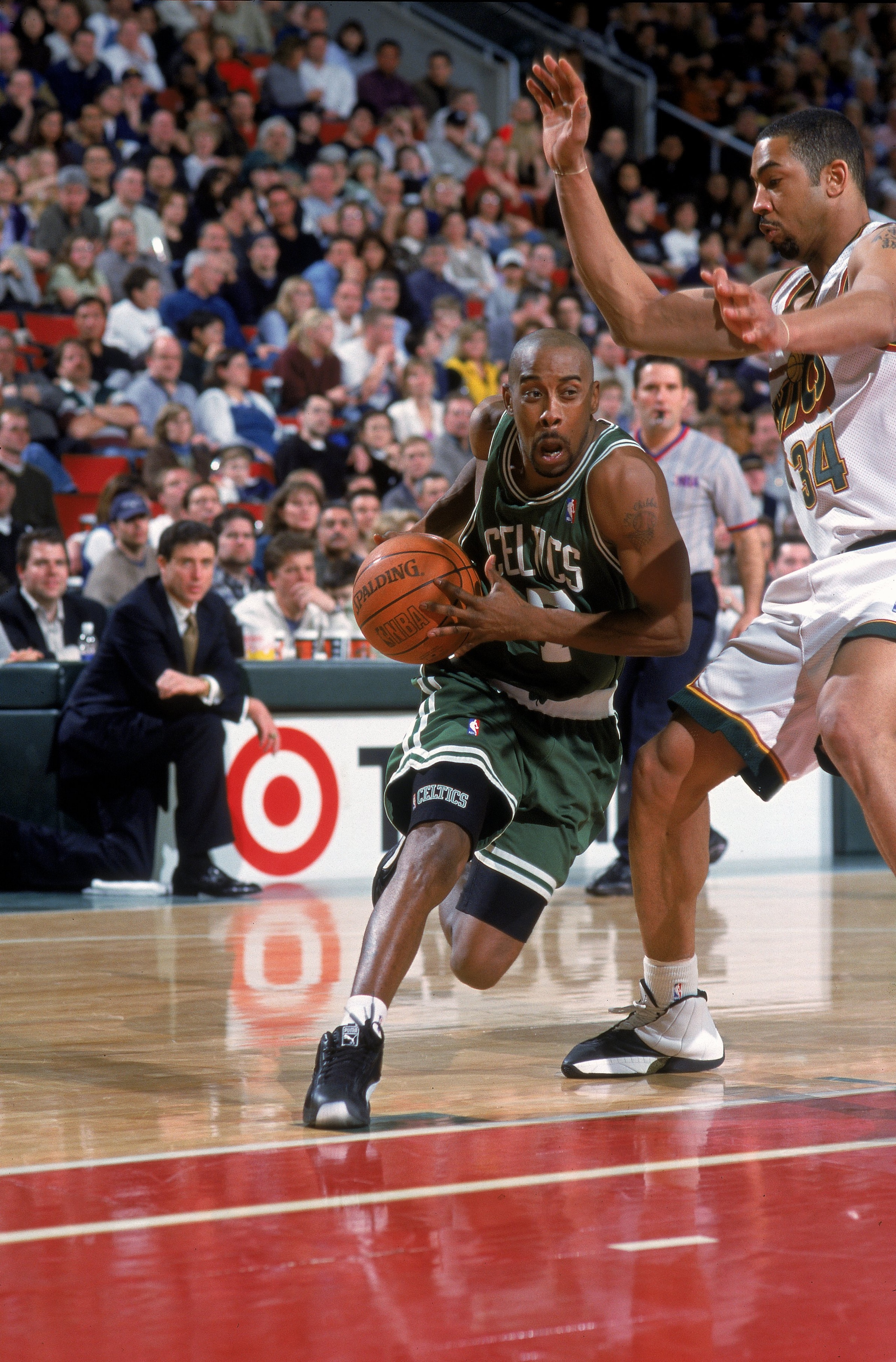 19 Feb 2000: Kenny Anderson #7 of the Boston Celtics moves with the ball around Jelani McCoy #34 of the Seattle SuperSoncis during the game at the Key Arena in Seattle, Washington. The Sonics defeated the Celtics 94-91..