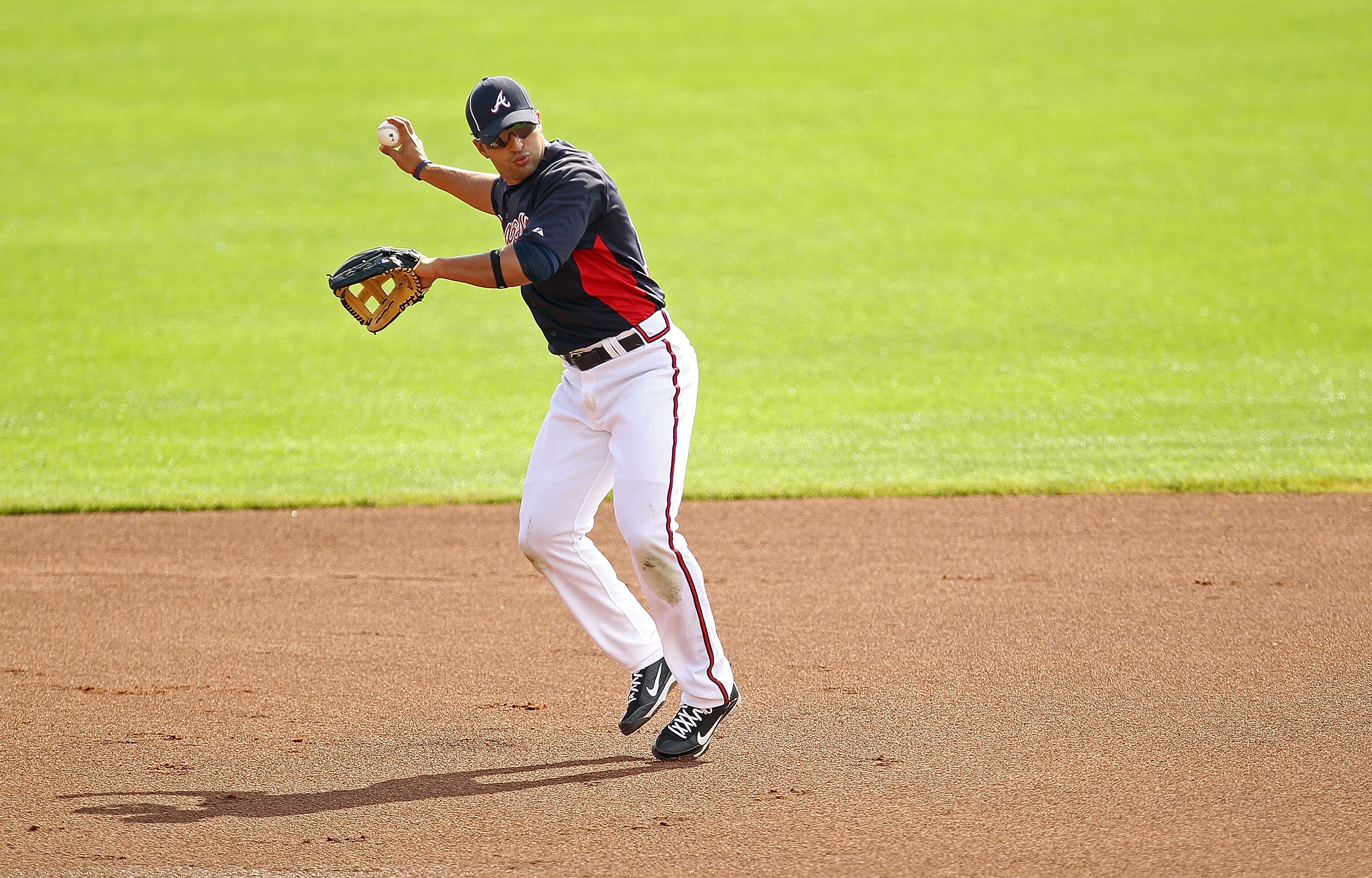 LAKE BUENA VISTA, FL - FEBRUARY 21:  Martin Prado #14 of the Atlanta Braves fields ground balls during a spring training workout at Champion Stadium on February 21, 2011 in Lake Buena Vista, Florida.  (Photo by Mike Ehrmann/Getty Images)