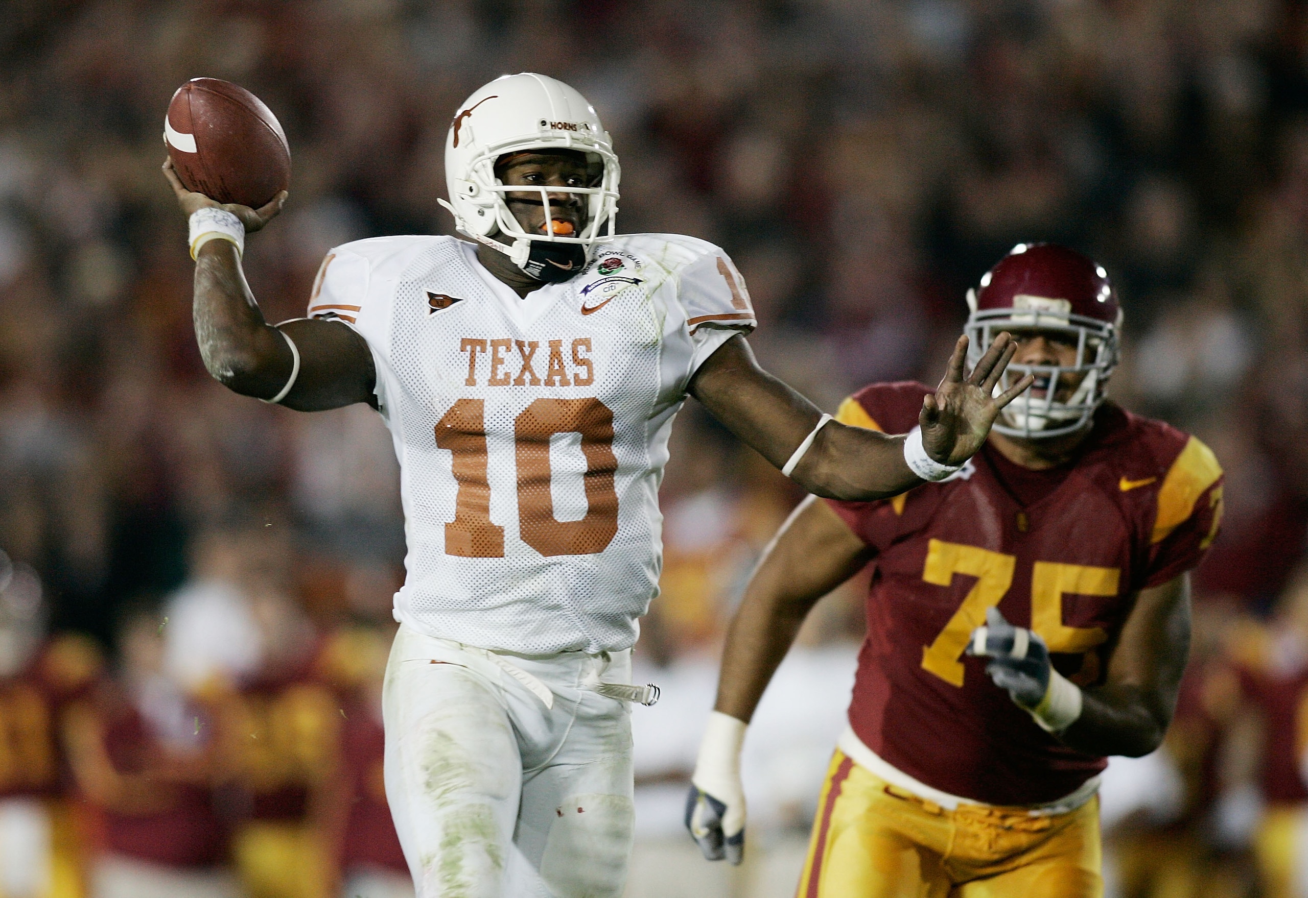 PASADENA, CA - JANUARY 04:  Quarterback Vince Young #10 of the Texas Longhorns fakes a pass before scoring on a 17-yard touchdown run against the USC Trojans in the fourth quarter during the BCS National Championship Rose Bowl Game on January 4, 2006 in P