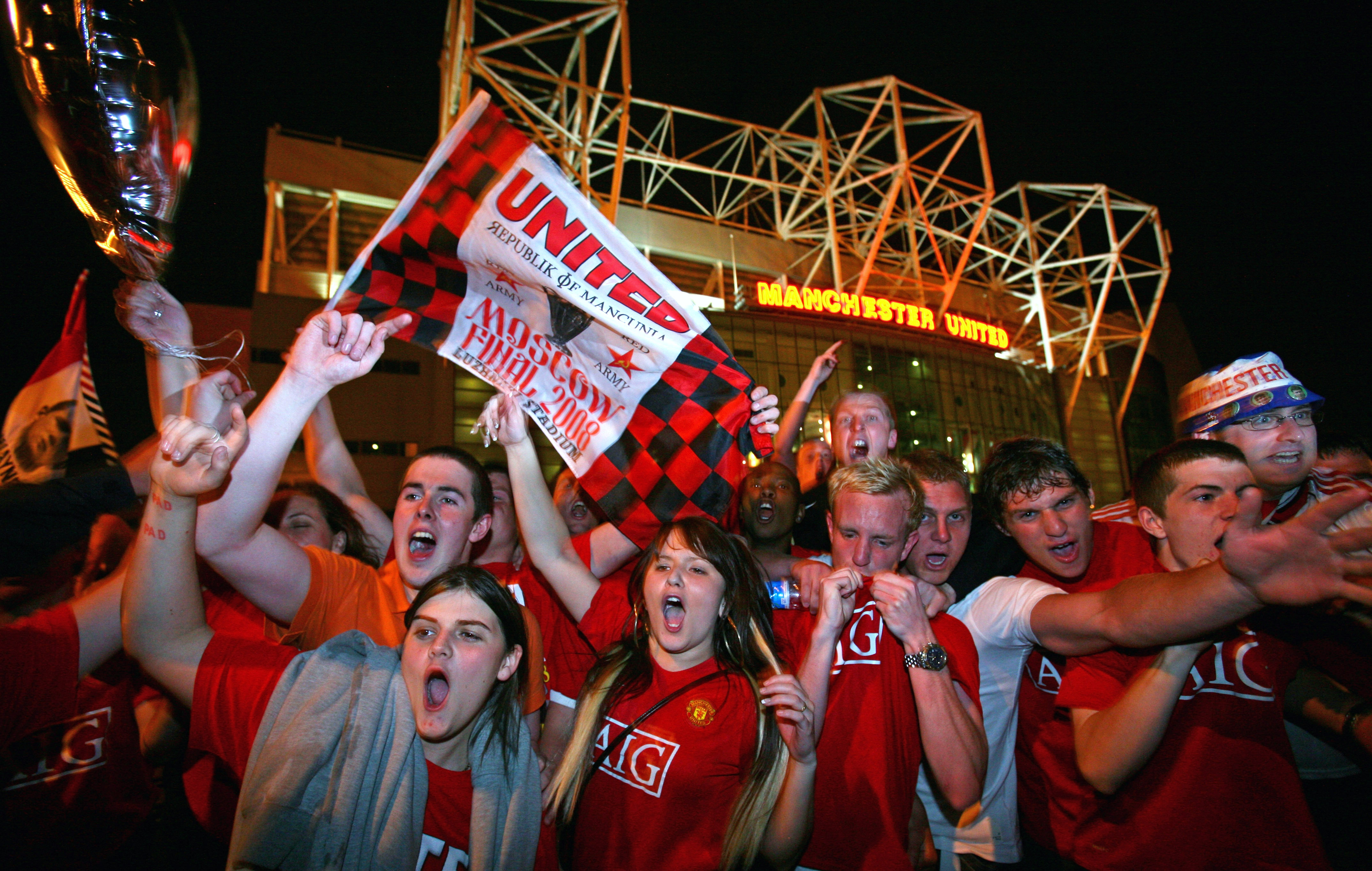 MANCHESTER - MAY 21:  Manchester United fans celebrate outside Old Trafford after their teams win in the UEFA Champions league final between Manchester United and Chelsea  May 21, 2008 in Manchester, England. Tonight was the first time that two English cl