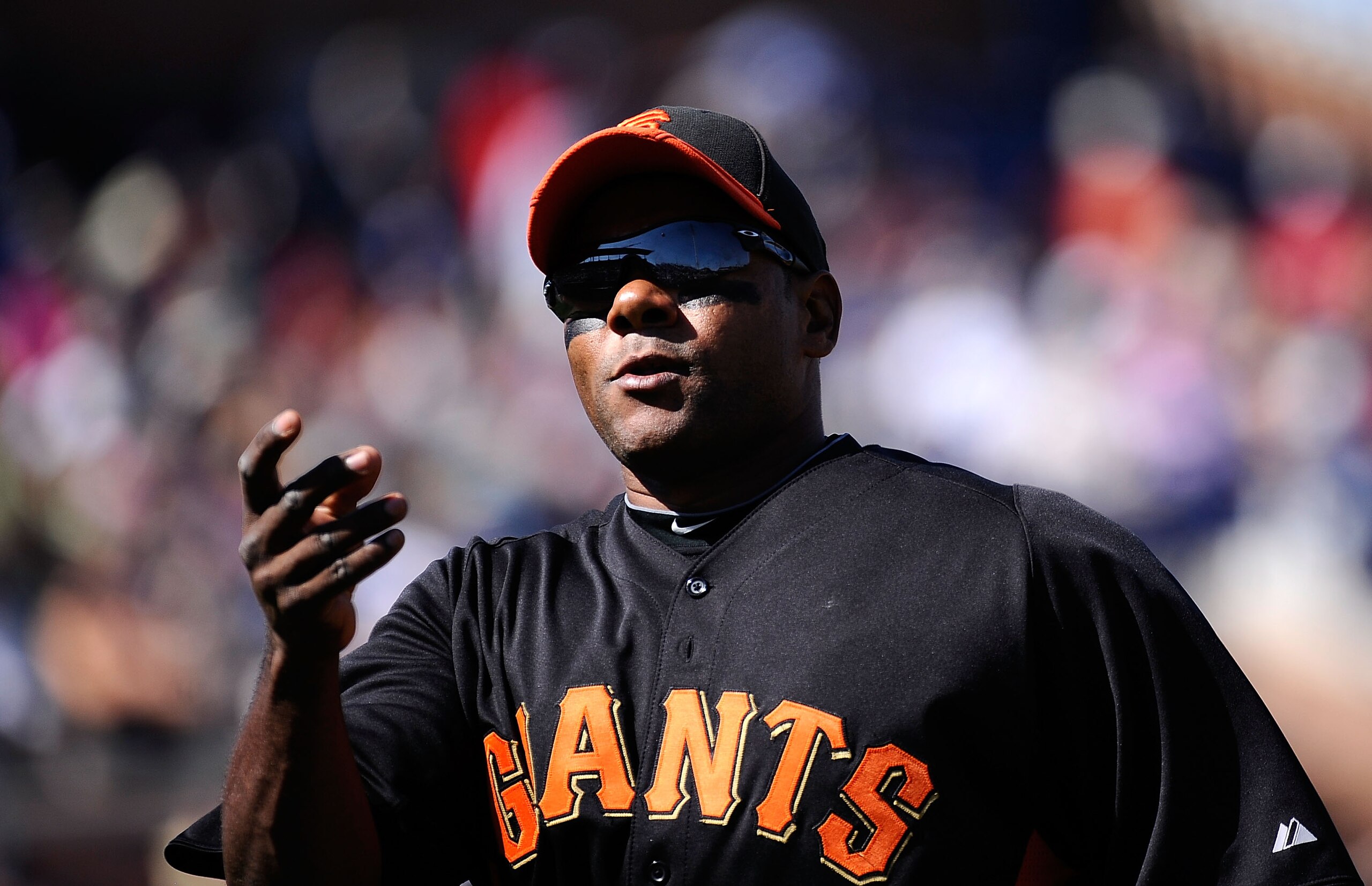 PEORIA, AZ - MARCH 08:  Miguel Tejada #10 of the San Francisco Giants holds the baseball as he runs to the dugout against Seattle Mariners during the spring training baseball game against at Peoria Stadium on March 8, 2011 in Peoria, Arizona.  (Photo by K