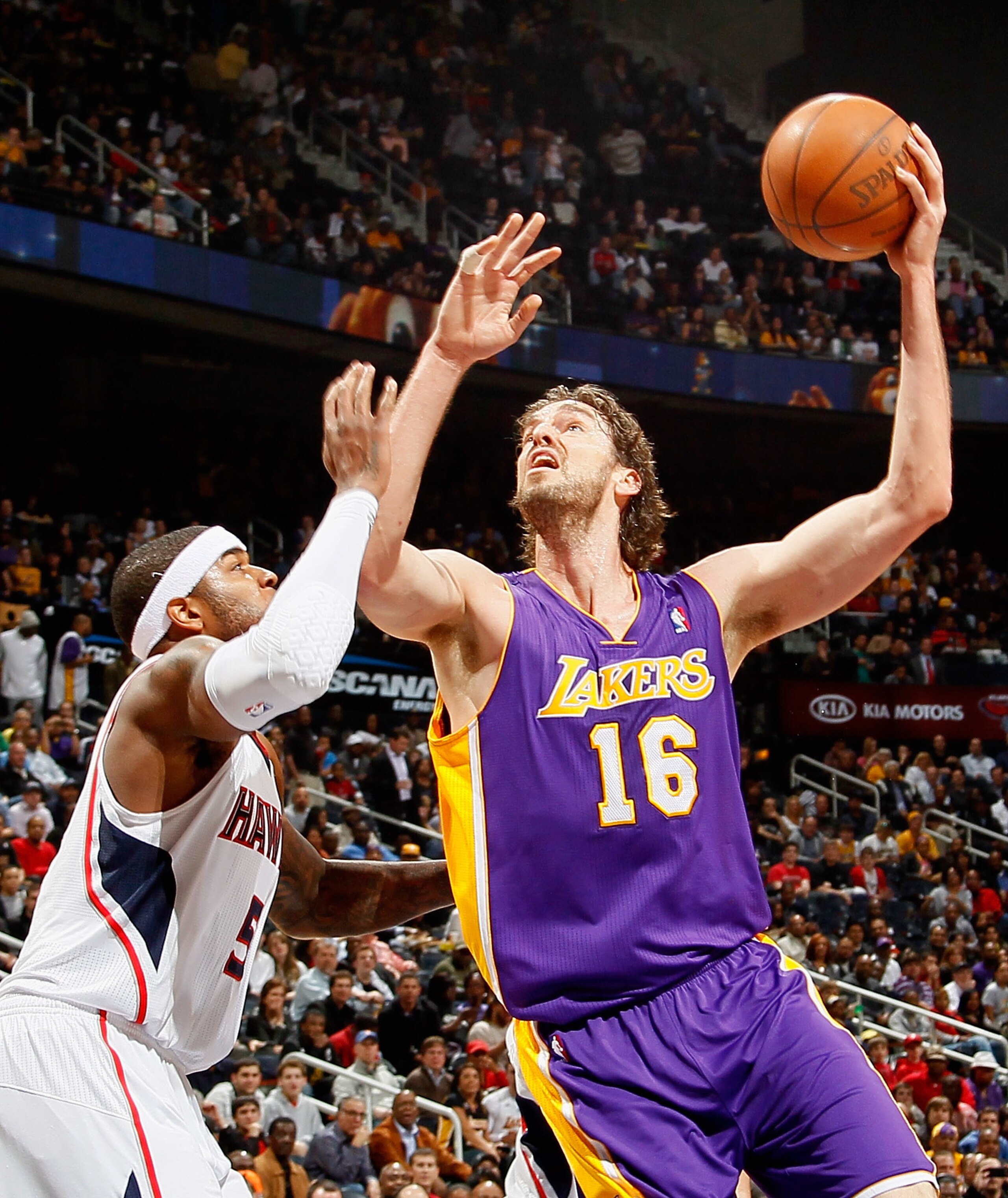 ATLANTA, GA - MARCH 08:  Pau Gasol #16 of the Los Angeles Lakers shoots over Josh Smith #5 of the Atlanta Hawks at Philips Arena on March 8, 2011 in Atlanta, Georgia.  NOTE TO USER: User expressly acknowledges and agrees that, by downloading and/or using