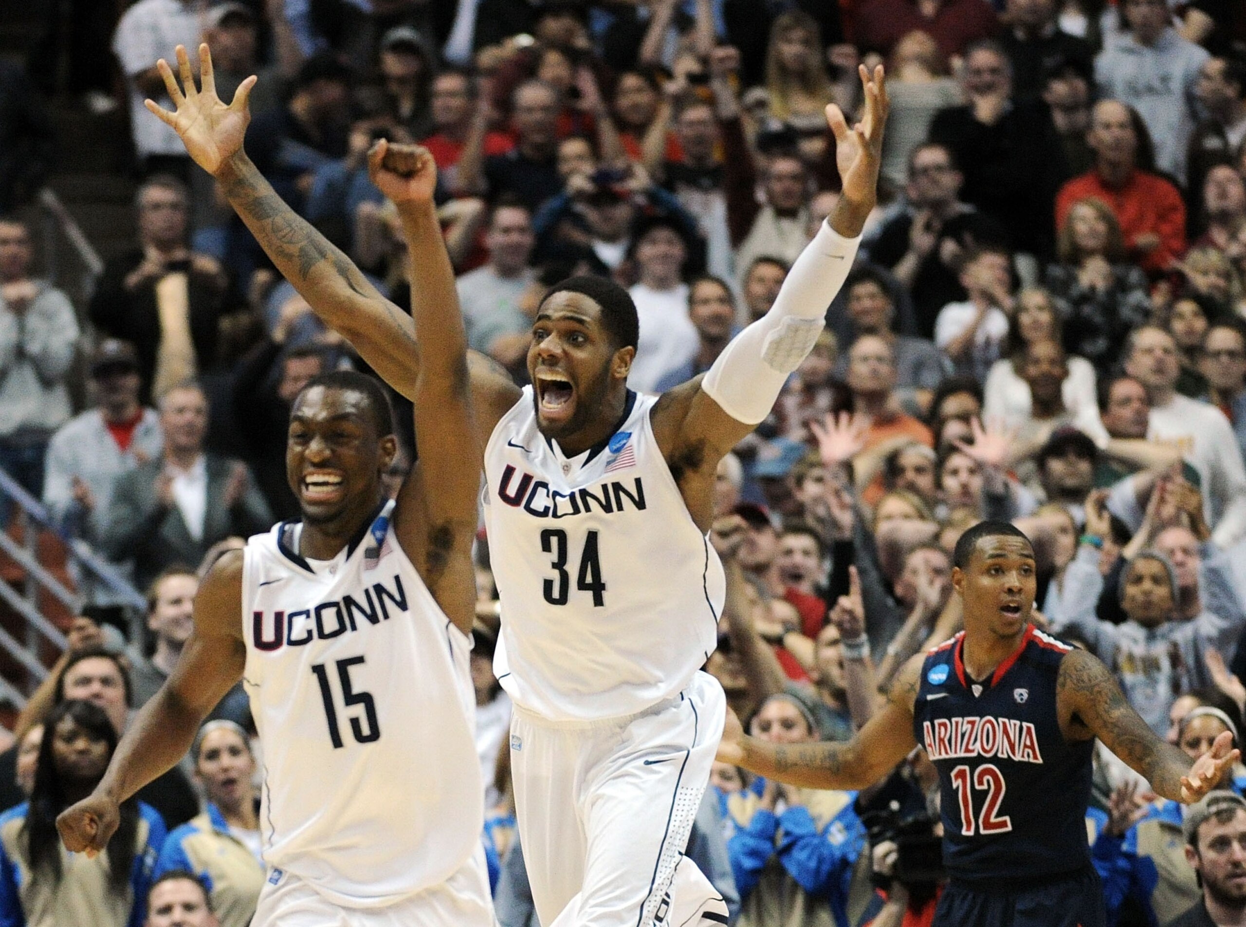 ANAHEIM, CA - MARCH 26:  Kemba Walker #15,  and Alex Oriakhi #34 of the Connecticut Huskies celebrate after defeating the Arizona Wildcats as Lamont Jones #12 looks on during the west regional final of the 2011 NCAA men's basketball tournament at the Hond