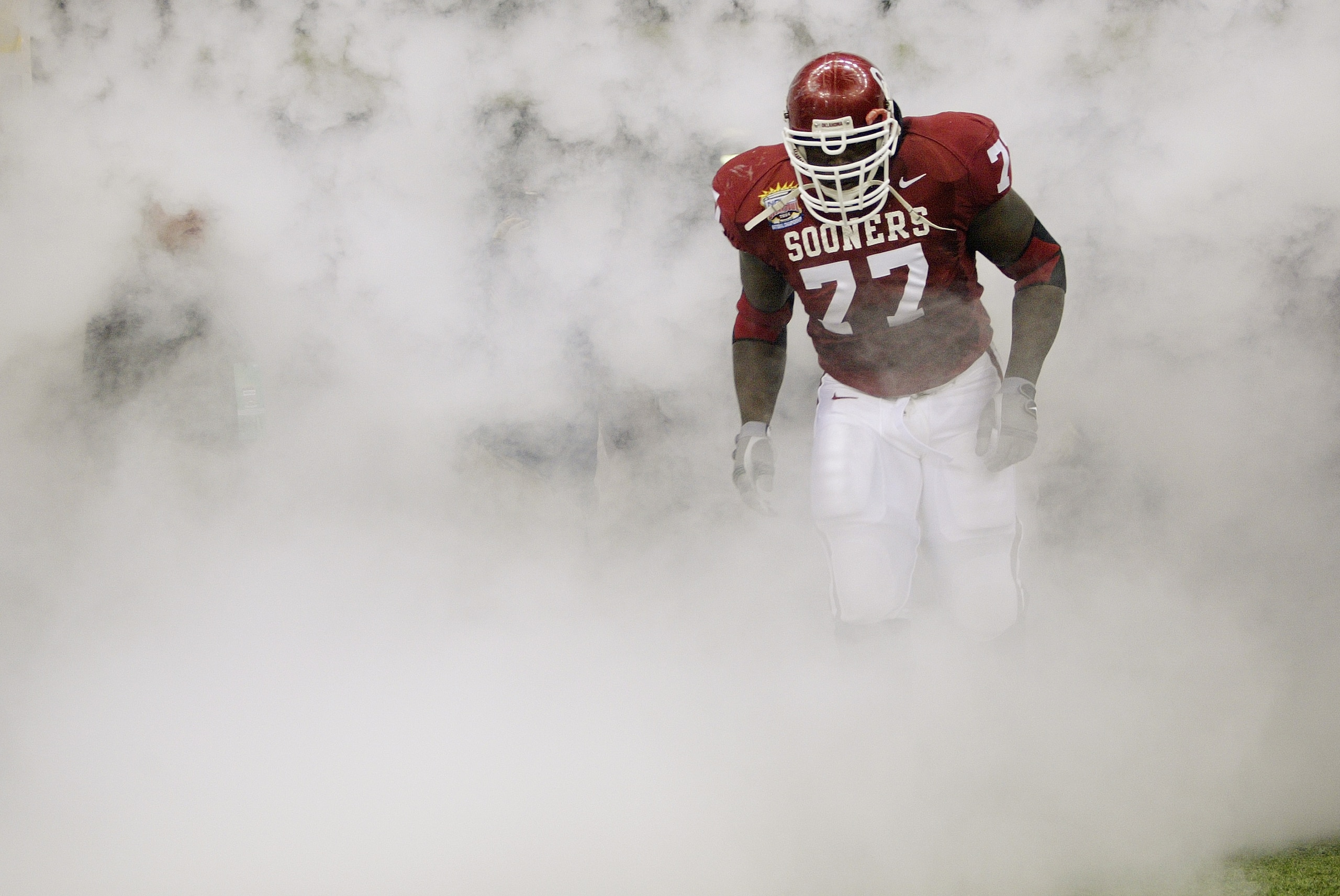 NEW ORLEANS - JANUARY 4:  Offensive lineman Davin Joseph #77 of the Oklahoma Sooners runs out of the tunnel before the game against the Louisiana State Tigers in the Nokia Sugar Bowl National Championship on January 4, 2004 at the Louisiana Superdome in N