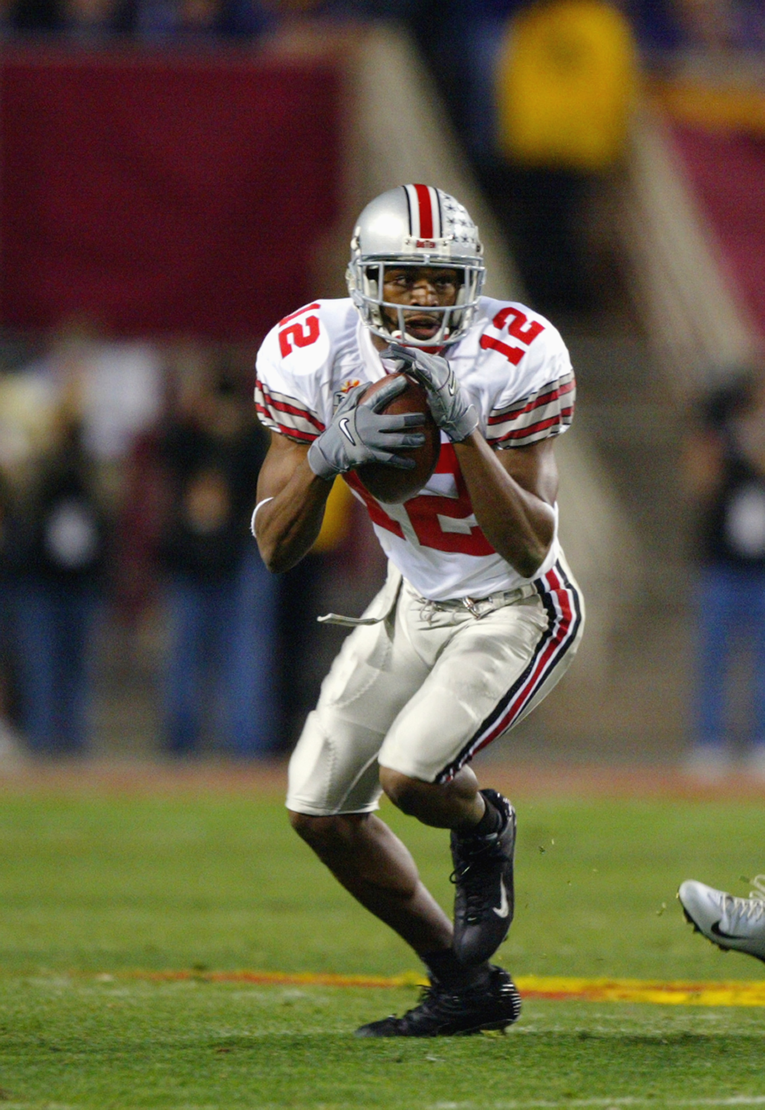 TEMPE, ARIZONA - JANUARY 2:  Wide receiver Michael Jenkins #12 of the Ohio State Buckeyes catches the ball during the game against the Kansas State Wildcats in the Tostitos Fiesta Bowl on January 2, 2004 at Sun Devil Stadium in Tempe, Arizona. The Buckeye