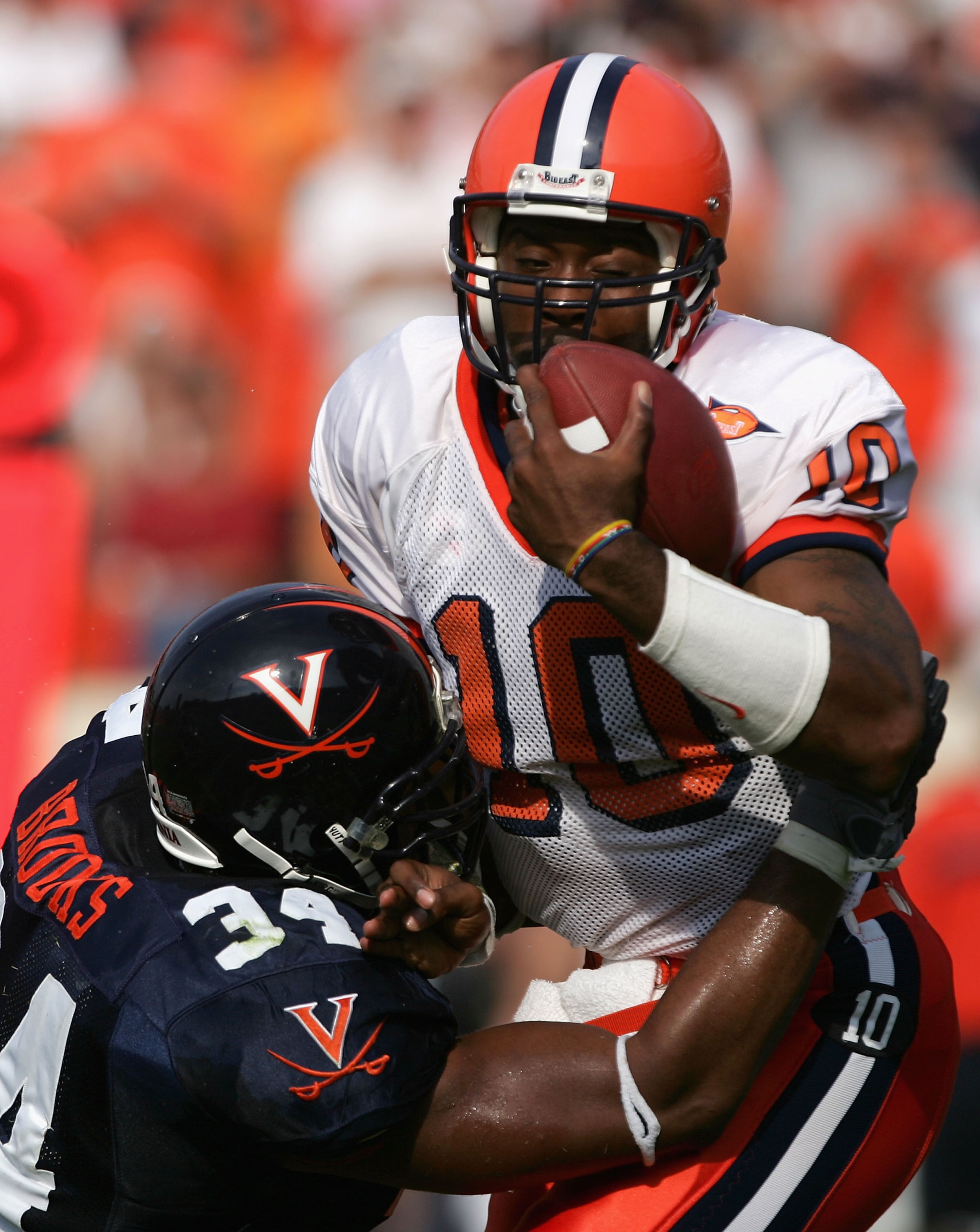 CHARLOTTESVILLE, VA - SEPTEMBER 25:   Ahmad Brooks #34 of the Virginia Cavaliers sacks quarterback Perry Patterson #10 of the Syracuse Orangemen in the first quarter for a loss during NCAA football at Scott Stadium on September 25, 2004 in Charlottesville