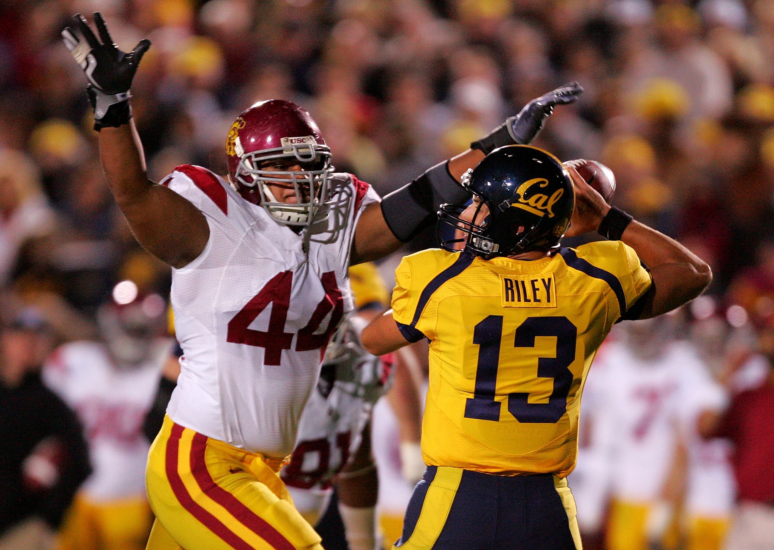 BERKELEY, CA - OCTOBER 03:  Kevin Riley #13 of the California Golden Bears is pressured by Christian Tupou #44 of the USC Trojans at California Memorial Stadium on October 3, 2009 in Berkeley, California.  (Photo by Ezra Shaw/Getty Images)