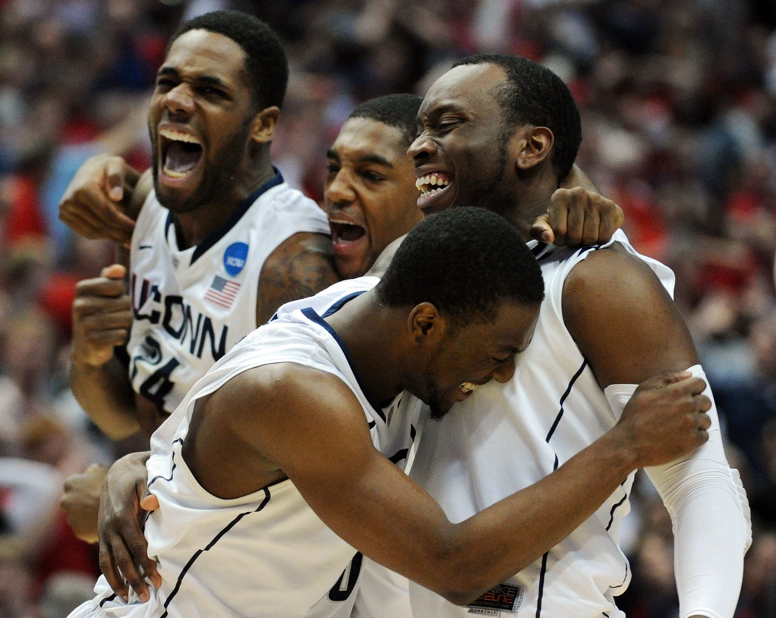 ANAHEIM, CA - MARCH 26:  Kemba Walker #15, Donnell Beverly #2, Roscoe Smith #22 and Alex Oriakhi #34 of the Connecticut Huskies celebrate after defeating the Arizona Wildcats during the west regional final of the 2011 NCAA men's basketball tournament at t