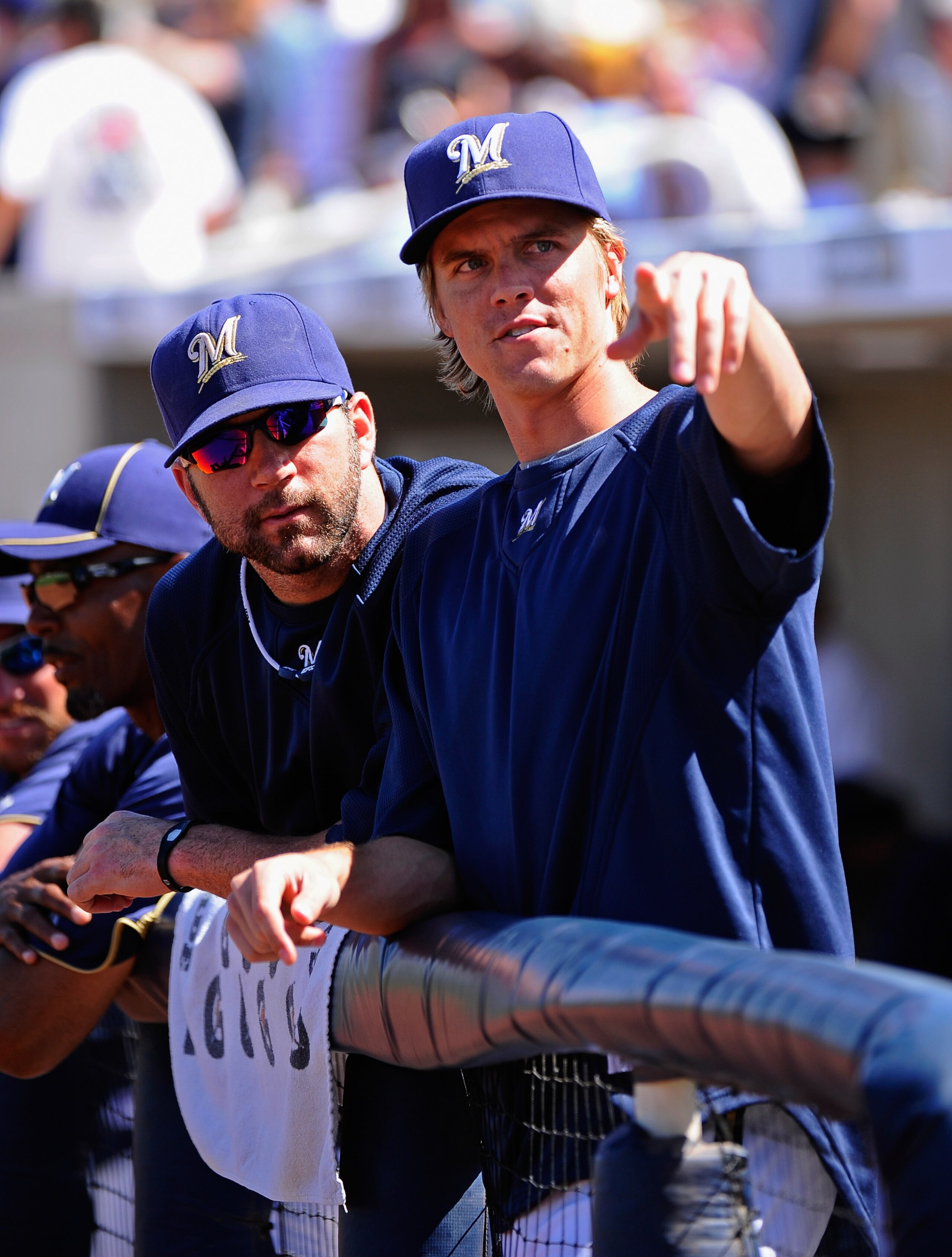 PHOENIX, AZ - MARCH 10:  Pitchers Zack Greinke #13 and Shaun Marcum #18  of the Milwaukee Brewers look at fans during the spring teaining baseball agme against Colorado Rockies at Maryvale Baseball Park on March 10, 2011 in Phoenix, Arizona.  (Photo by Ke