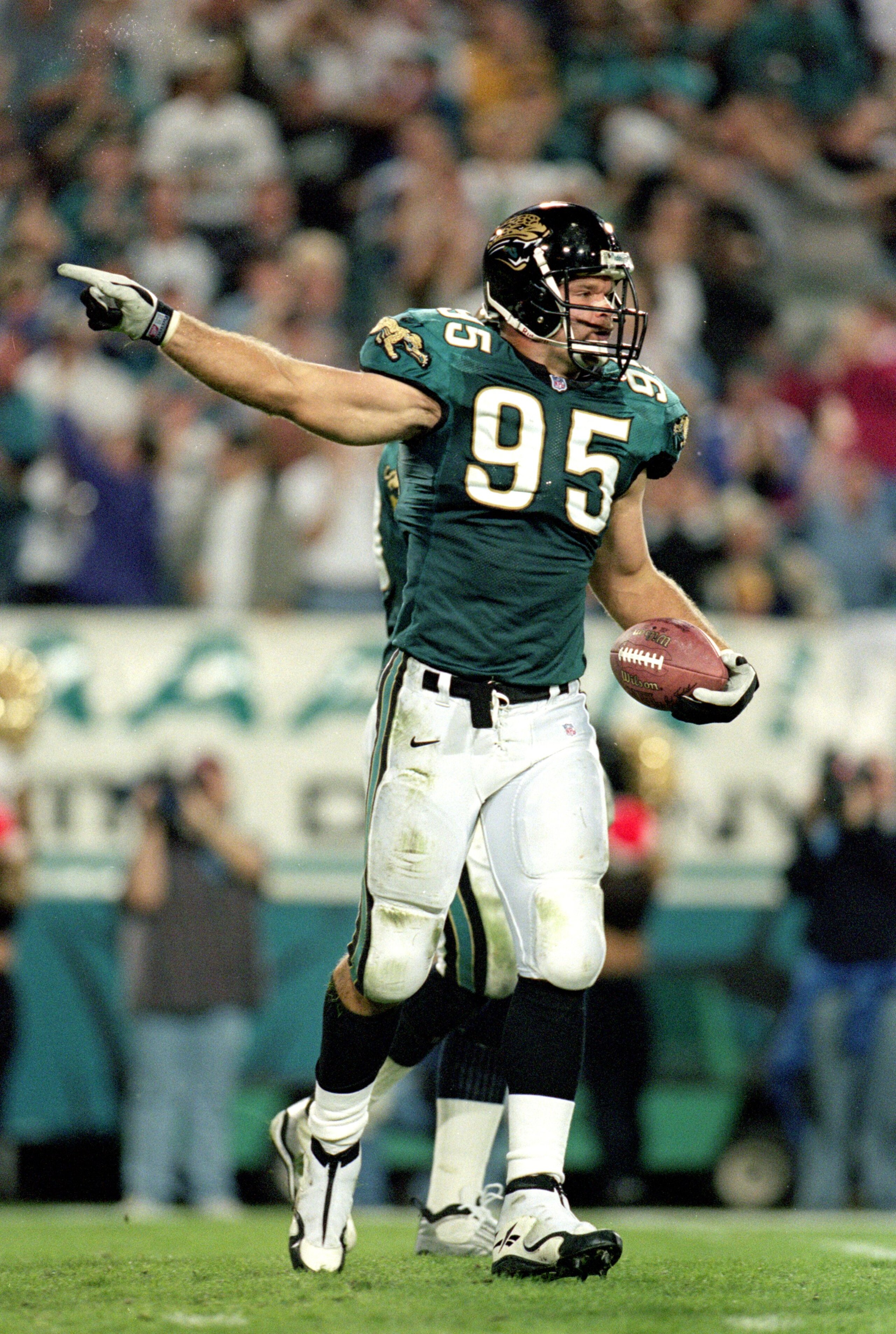 13 Dec 1999:  Bryce Poup #95 of the Jacksonville Jaguars carries the ball as he recovers a fumble during a game against the Denver Broncos at the Altell Stadium in Jacksonville, Florida. The Jaguars defeated the Broncos 27-24. Mandatory Credit: Andy Lyons