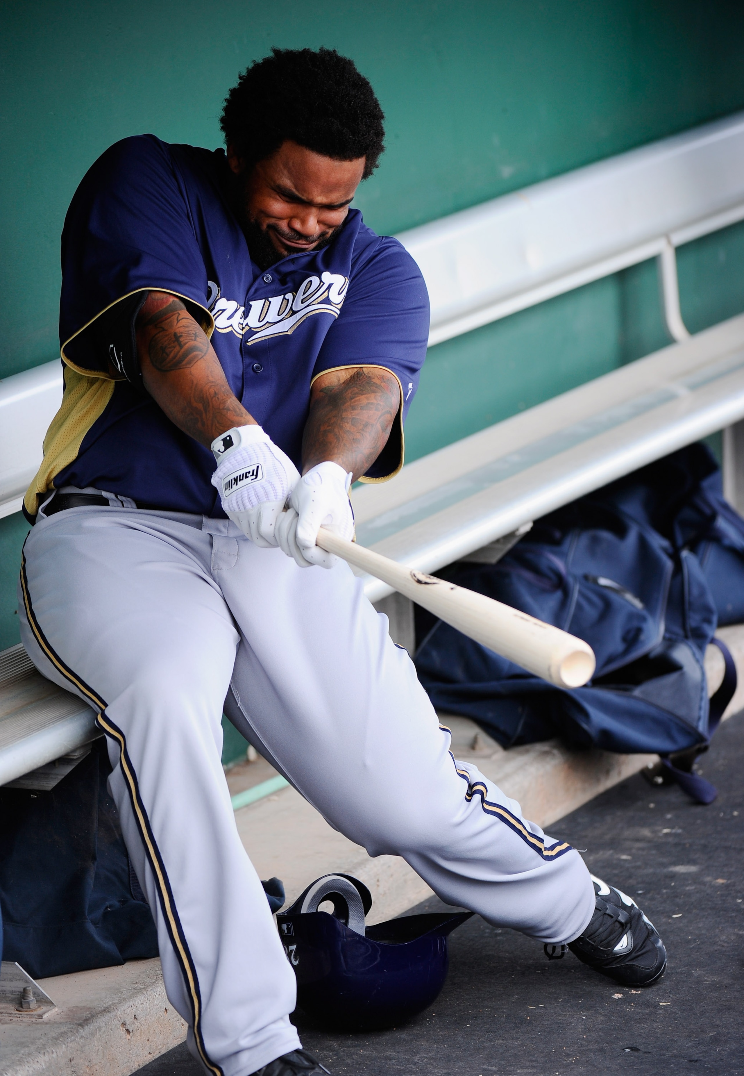 SCOTTSDALE, AZ - MARCH 14:  Prince Fielder#28 of the Milwaukee Brewers swings the bat in the dugout prior to the start of the spring training baseball game against the San Francisco Giants during the spring training baseball game at Scottsdale Stadium on