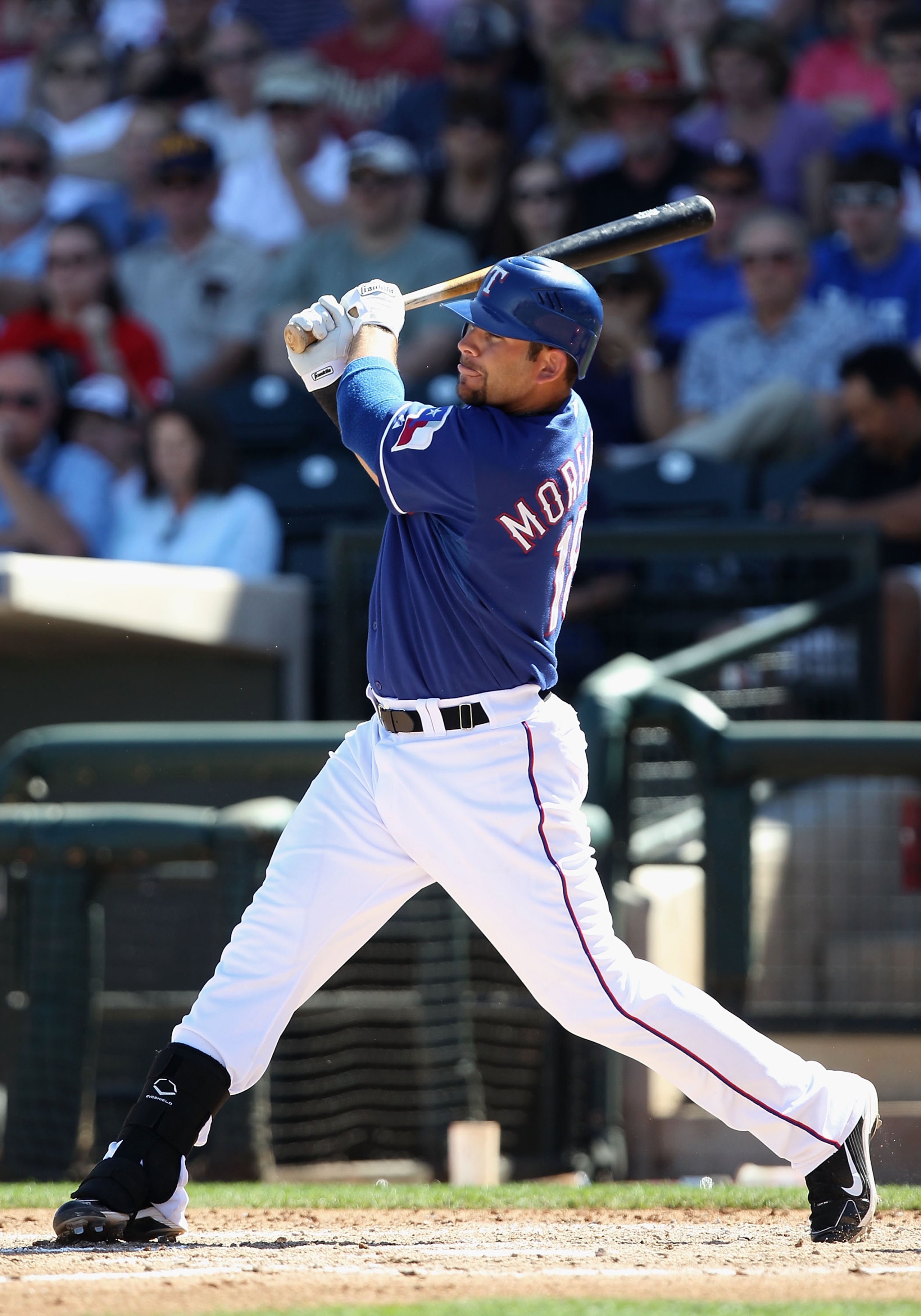 SURPRISE, AZ - MARCH 11:  Mitch Moreland #18 of the Texas Rangers hits a RBI double against the Cincinnati Reds during the second inning of the spring training game at Surprise Stadium on March 11, 2011 in Surprise, Arizona.  (Photo by Christian Petersen/