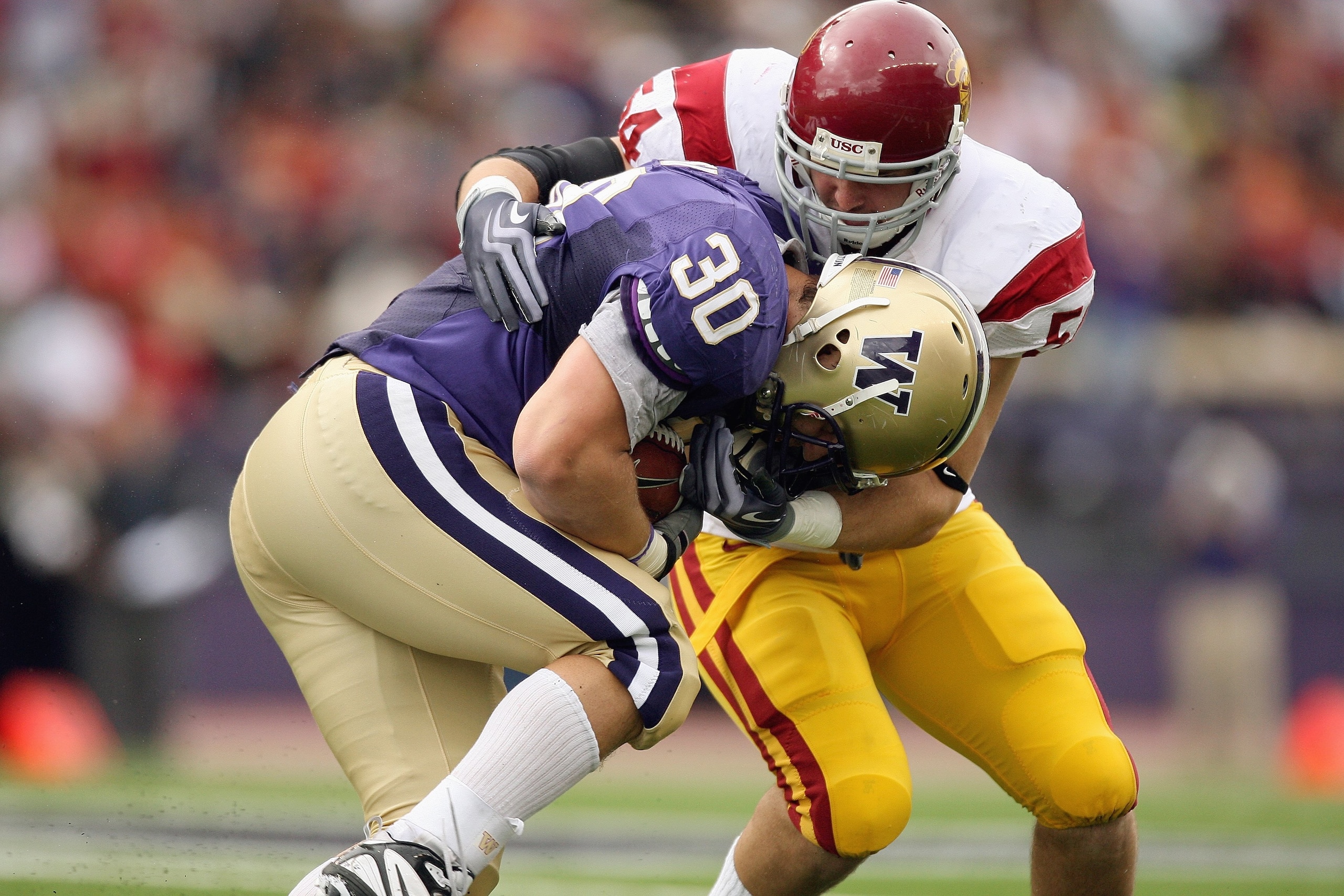 SEATTLE - SEPTEMBER 19: Paul Homer #30 of the Washington Huskies carries the ball as he is tackled by Chris Galippo #54 of the USC Trojans on September 19, 2009 at Husky Stadium in Seattle, Washington. The Huskies defeated the Trojans 16-13. (Photo by Ott
