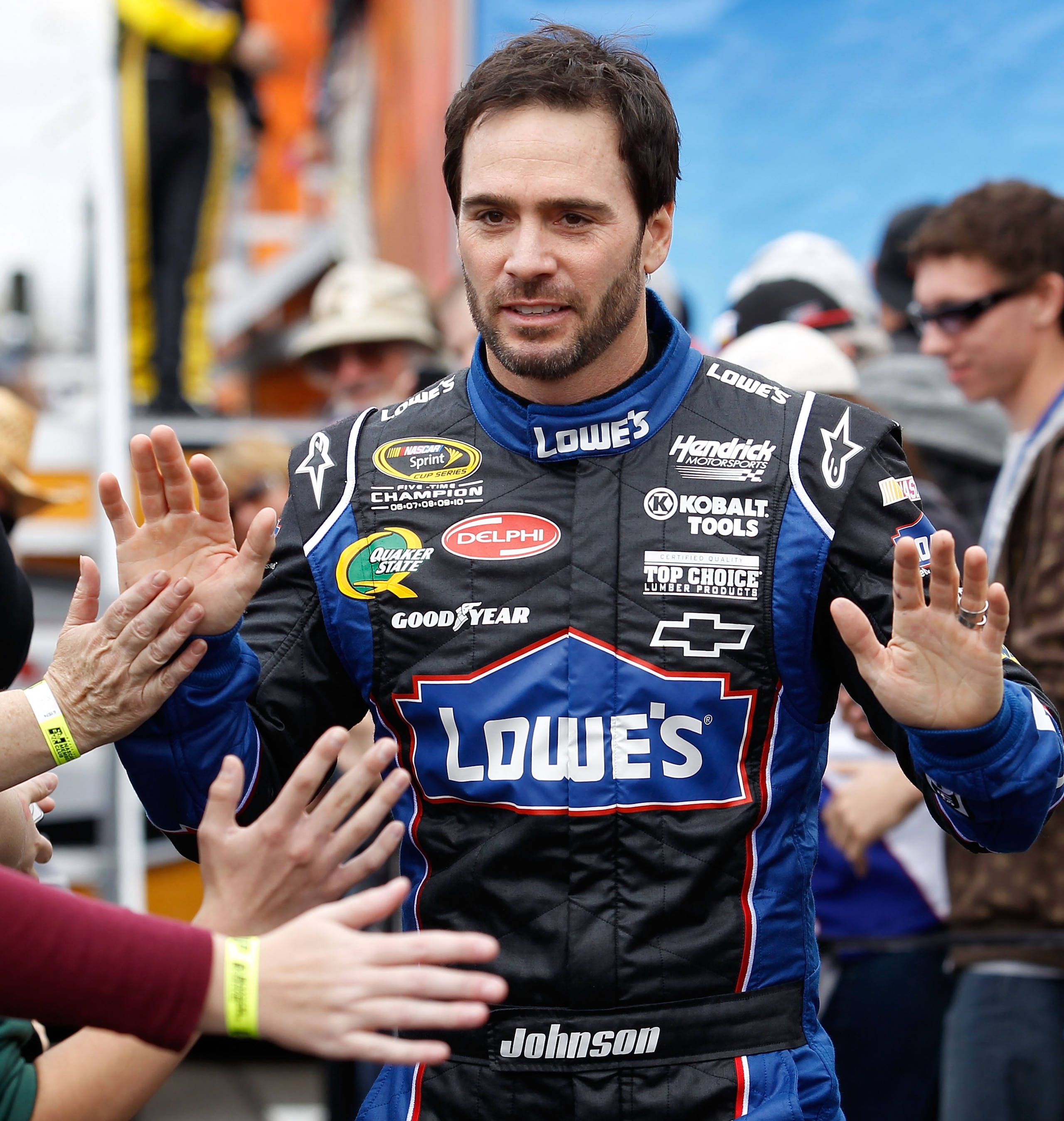 FONTANA, CA - MARCH 27:  Jimmie Johnson, driver of the #48 Lowe's Chevrolet, greets fans during driver introductions for the NASCAR Sprint Cup Series Auto Club 400 at Auto Club Speedway on March 27, 2011 in Fontana, California.  (Photo by Todd Warshaw/Get