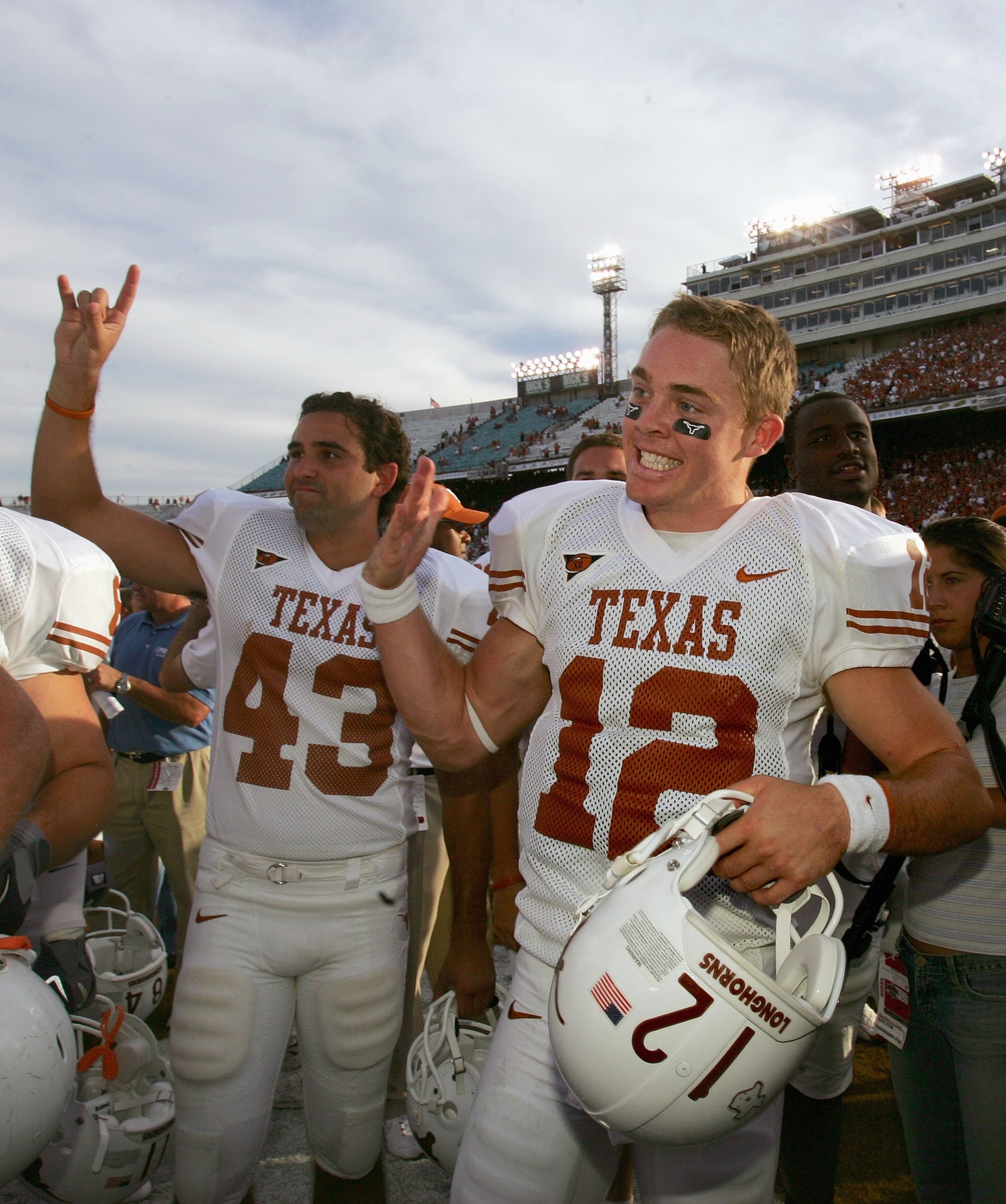 DALLAS - OCTOBER 7:  Quarterback Colt McCoy #12 and punt kicker Justin Moore #43 of the Texas Longhorns raise the Hold 'em Horns sign after winning the game against the Oklahoma Sooners during the Red River Shootout at the Cotton Bowl on October 7, 2006 i