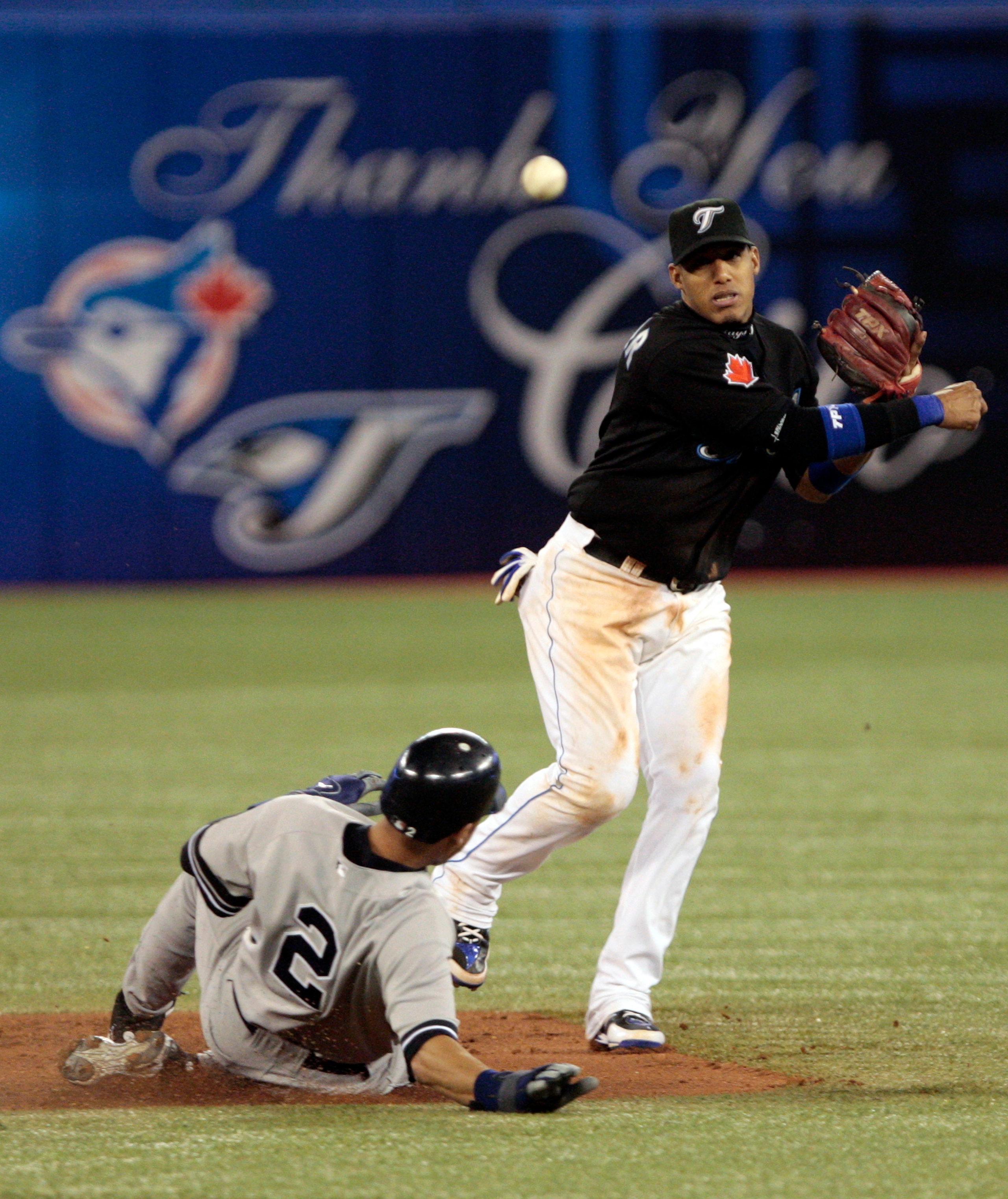 TORONTO, ON - SEPTEMBER 29:  Yunel Escobar #5 of the Toronto Blue Jays makes the double play on Derek Jeter #2 of the New York Yankees during a MLB game at the Rogers Centre September 29, 2010 in Toronto, Ontario, Canada. (Photo by Abelimages/Getty Images
