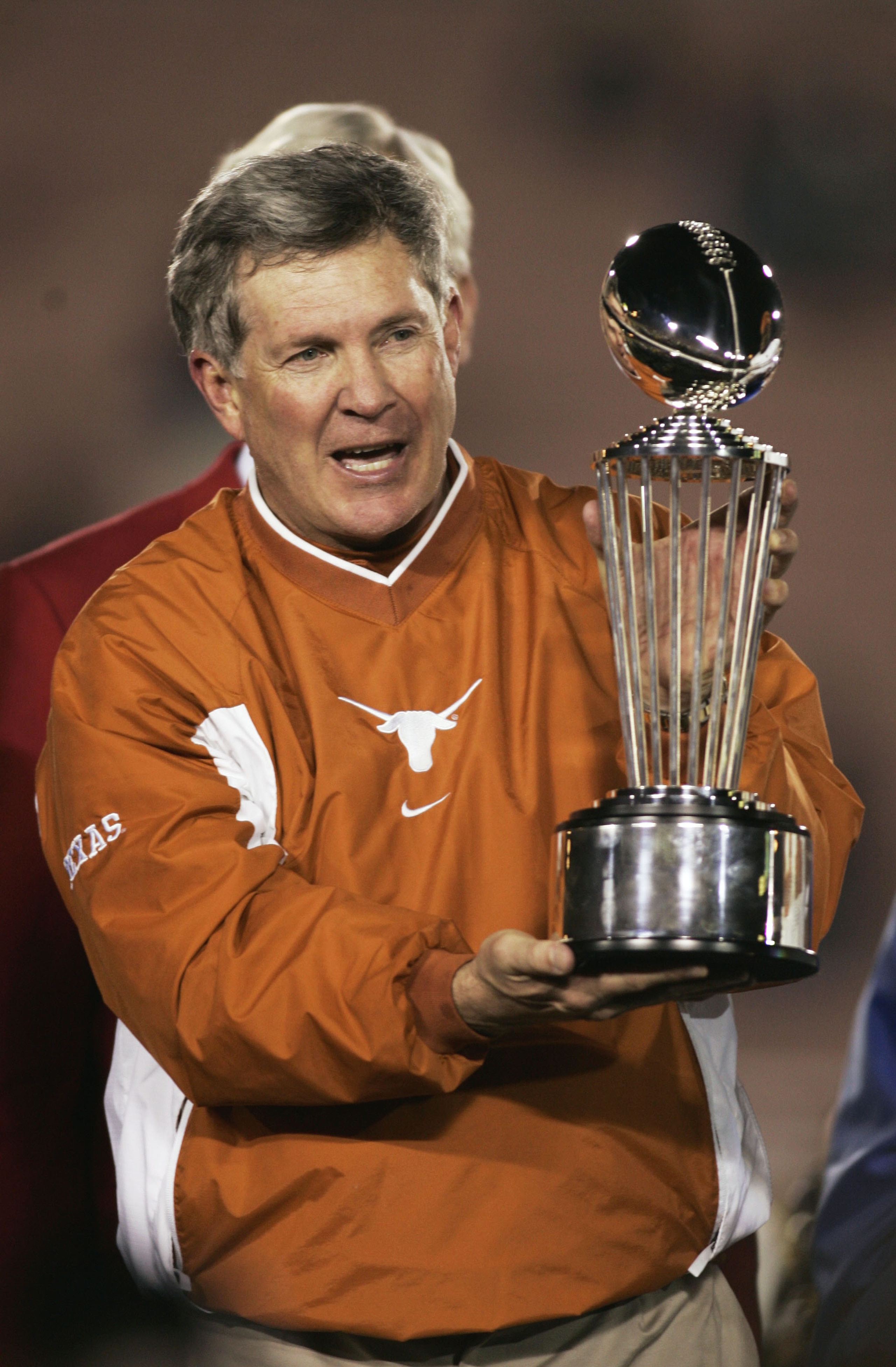 PASADENA, CA - JANUARY 1:   Head coach Mack Brown of the Texas Longhorns holds the Rose Bowl trophy while celebrating his team's victory over the Michigan Wolverines in the 91st Rose Bowl Game at the Rose Bowl on January 1, 2005 in Pasadena, California. T