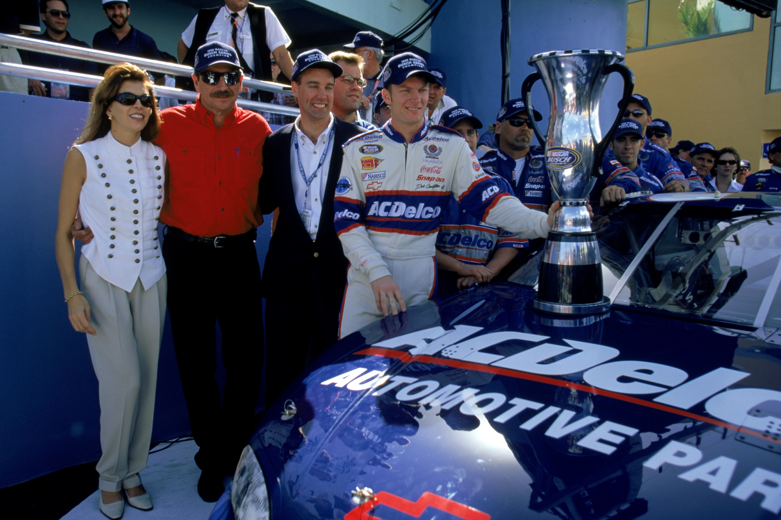 HOMESTEAD, FL - NOVEMBER 13:  Dale Earnhardt Sr. (center left), owner of the Busch car, poses with driver Dale Earnhardt Jr. (far right) and Teresa Earnhardt after the win in the Hotwheels.com 300 at the Homestead Miami Speedway on November 13, 1999 in Ho