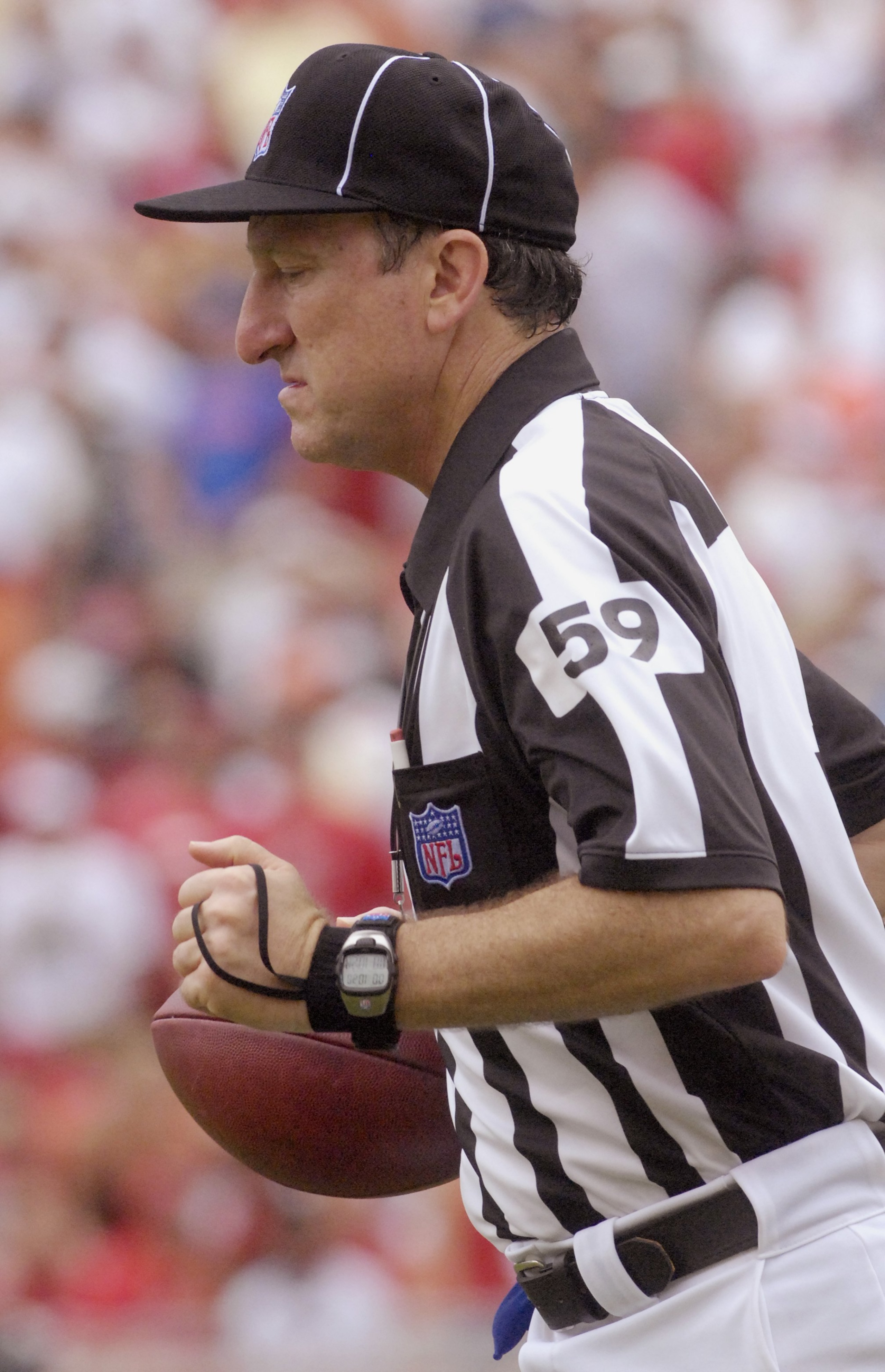 TAMPA, FL - SEPTEMBER 23:  NFL back judge Phil Luckett #59 sets a football as the Tampa Bay Buccaneers host the St. Louis Rams at Raymond James Stadium on September 23, 2007 in Tampa, Florida. The Bucs won 24 - 3. (Photo by Al Messerschmidt/Getty Images)