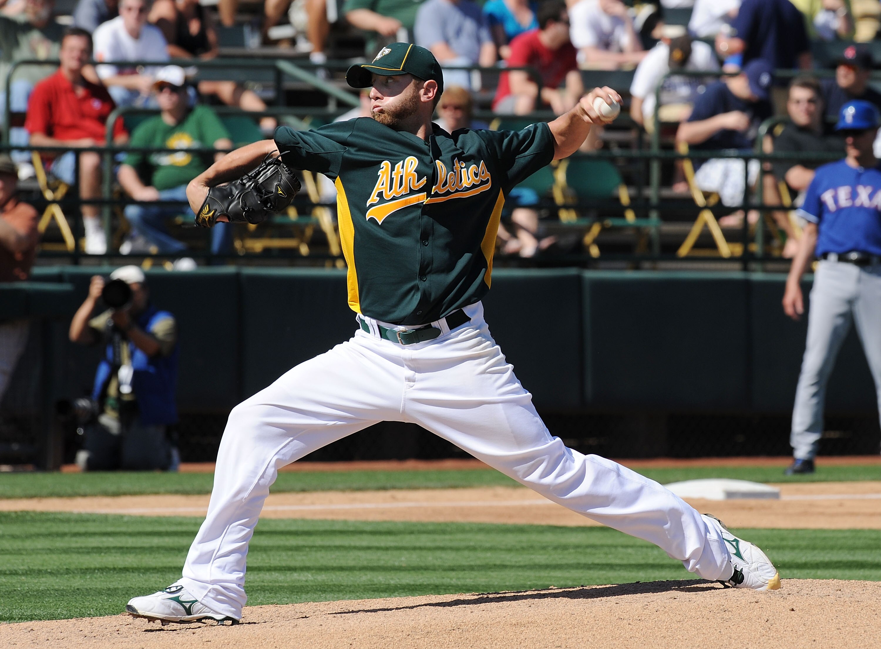PHOENIX, AZ - MARCH 04:  Dallas Braden #51 of the Oakland Athletics delivers a pitch against the Texas Rangers at Phoenix Municipal Stadium on March 4, 2011 in Phoenix, Arizona.  (Photo by Norm Hall/Getty Images)