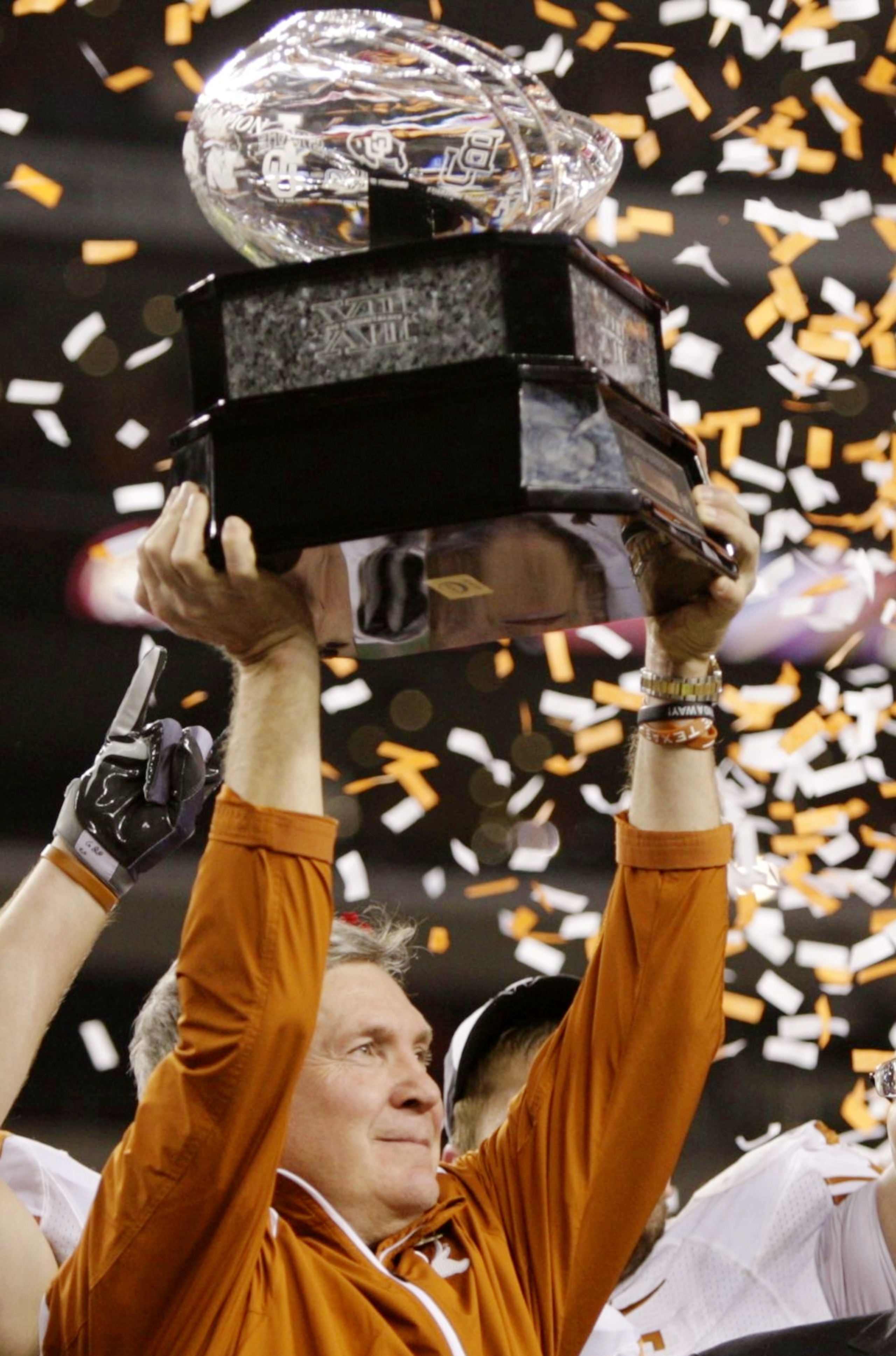 ARLINGTON, TX - DECEMBER 5: Head coach Mack Brown of the Texas Longhorns lifts the trophy after his teams 10-6 victory over the Nebraska Cornhuskers in the game at Cowboys Stadium on December 5, 2009 in Arlington, Texas.  (Photo by Jamie Squire/Getty Imag