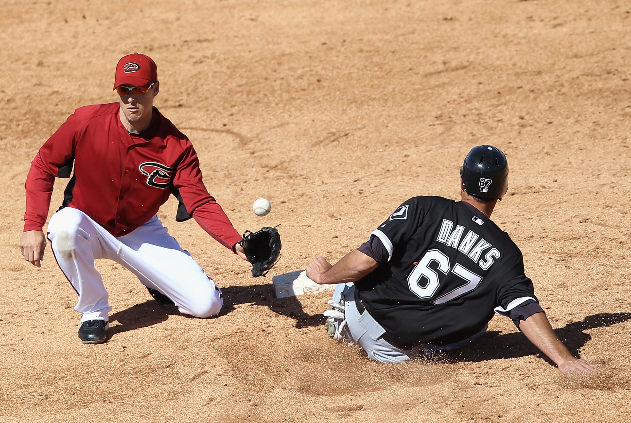 TUCSON, AZ - MARCH 07:  Jordan Danks #67 of the Chicago White Sox safely steals second base past infielder Kelly Johnson #2 of the Arizona Diamondbacks during the fifth inning of the spring training game at Kino Veterans Memorial Stadium on March 7, 2011
