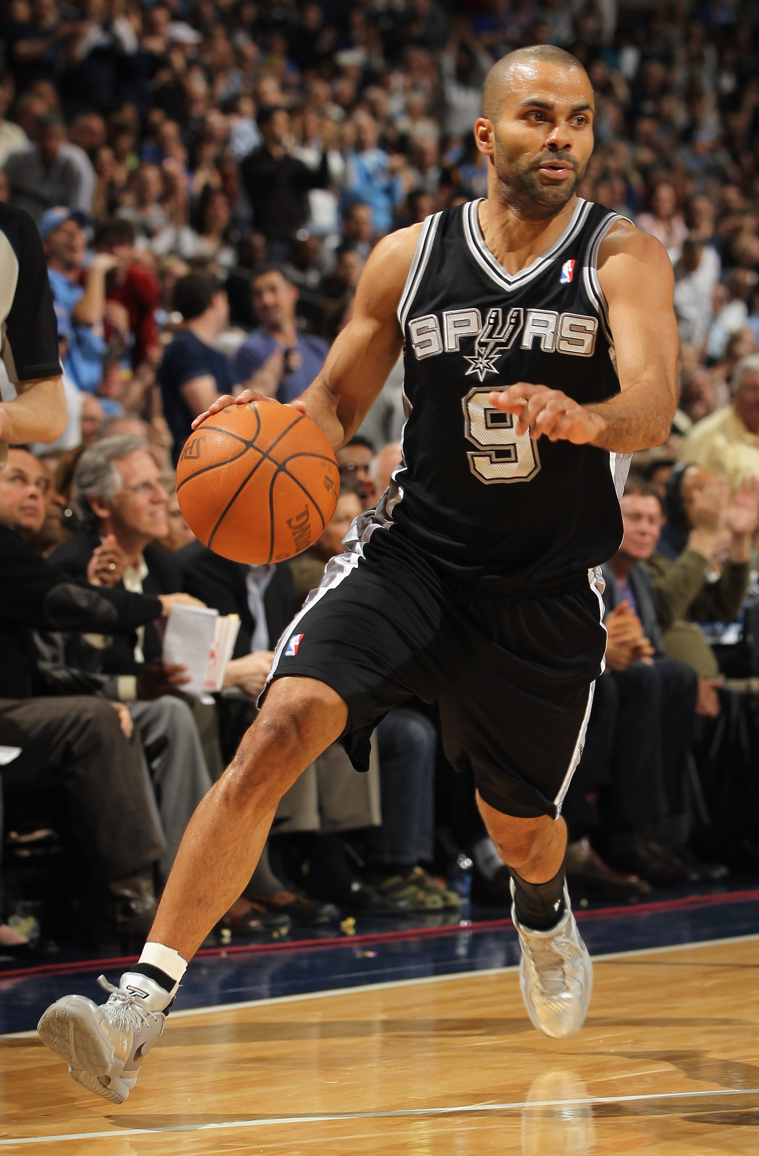 DENVER, CO - MARCH 23:  Tony Parker #9 of the San Antonio Spurs dribbles the ball against  the Denver Nuggets at the Pepsi Center on March 23, 2011 in Denver, Colorado. The Nuggets defeated the Spurs 115-112. NOTE TO USER: User expressly acknowledges and