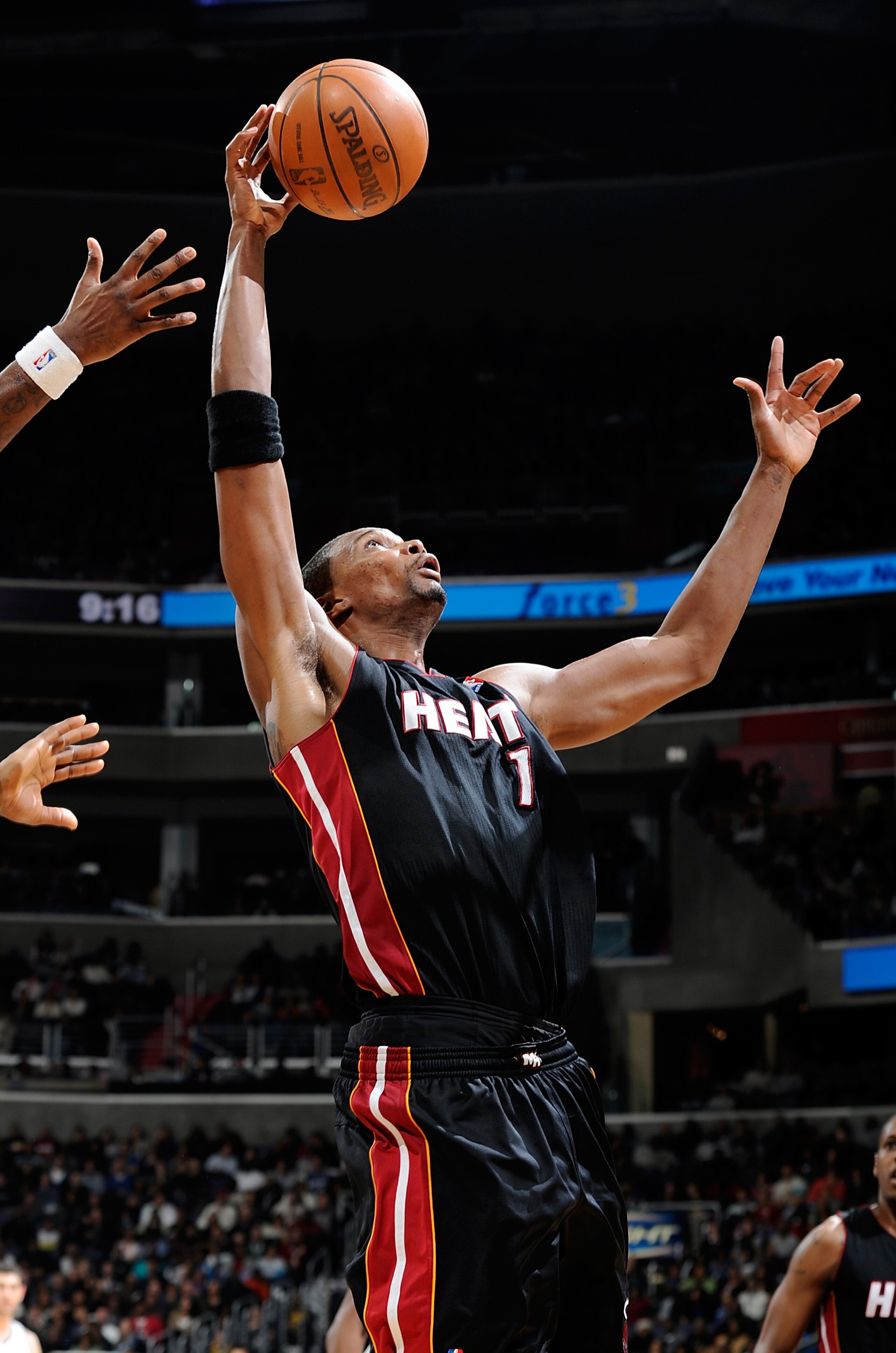 WASHINGTON, DC - DECEMBER 18:  Chris Bosh #1 of the Miami Heat grabs a rebound against the Washington Wizards at the Verizon Center on December 18, 2010 in Washington, DC. NOTE TO USER: User expressly acknowledges and agrees that, by downloading and or us