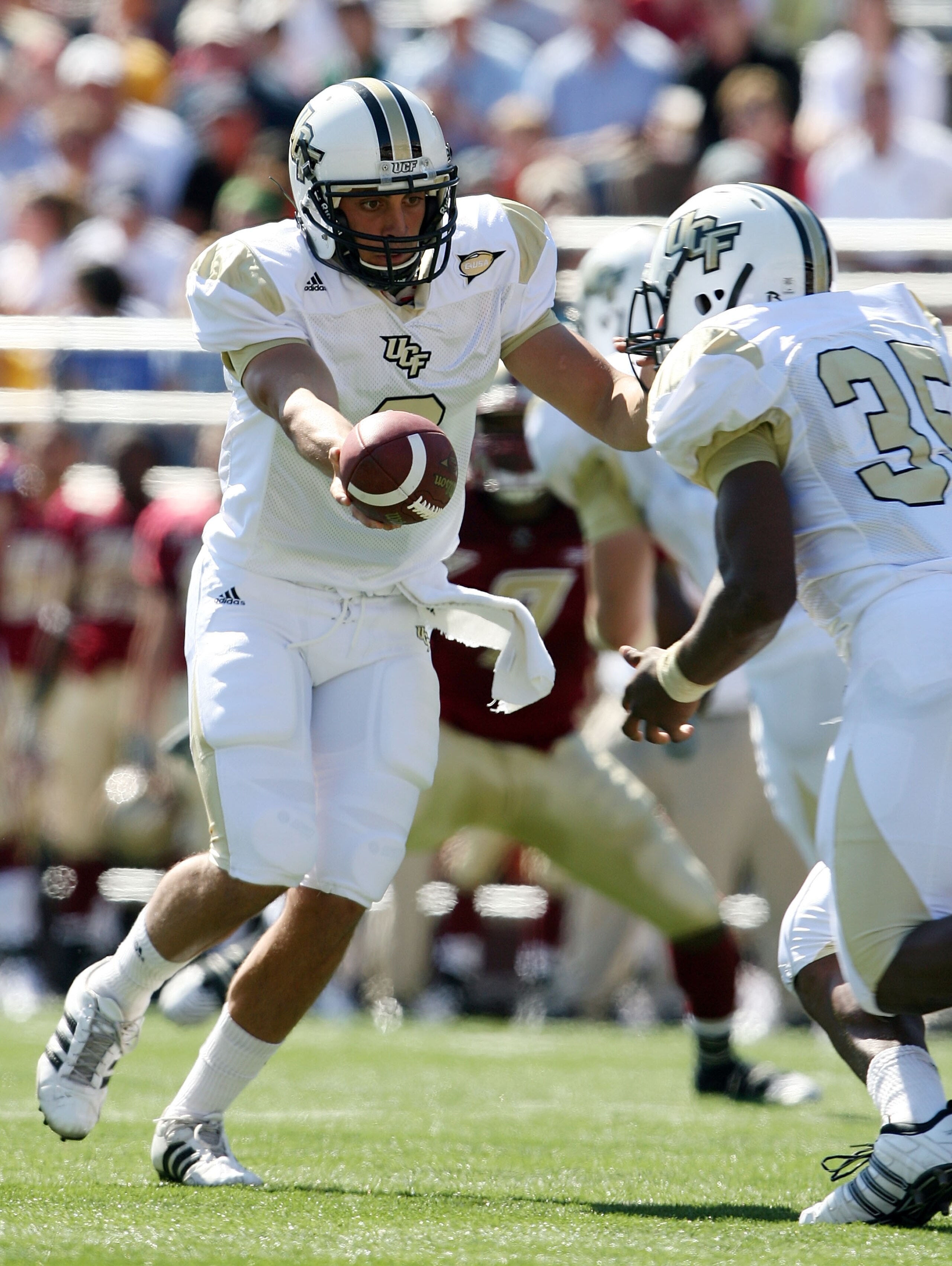 CHESTNUT HILL, MA - SEPTEMBER 20:  Michael Greco #2 of the Central Florida Knights hands the ball off to Ronnie Weaver #35 in the first half against the Boston College Eagles on September 20, 2008 at Alumni Stadium in Chestnut Hill, Massachusetts.  (Photo
