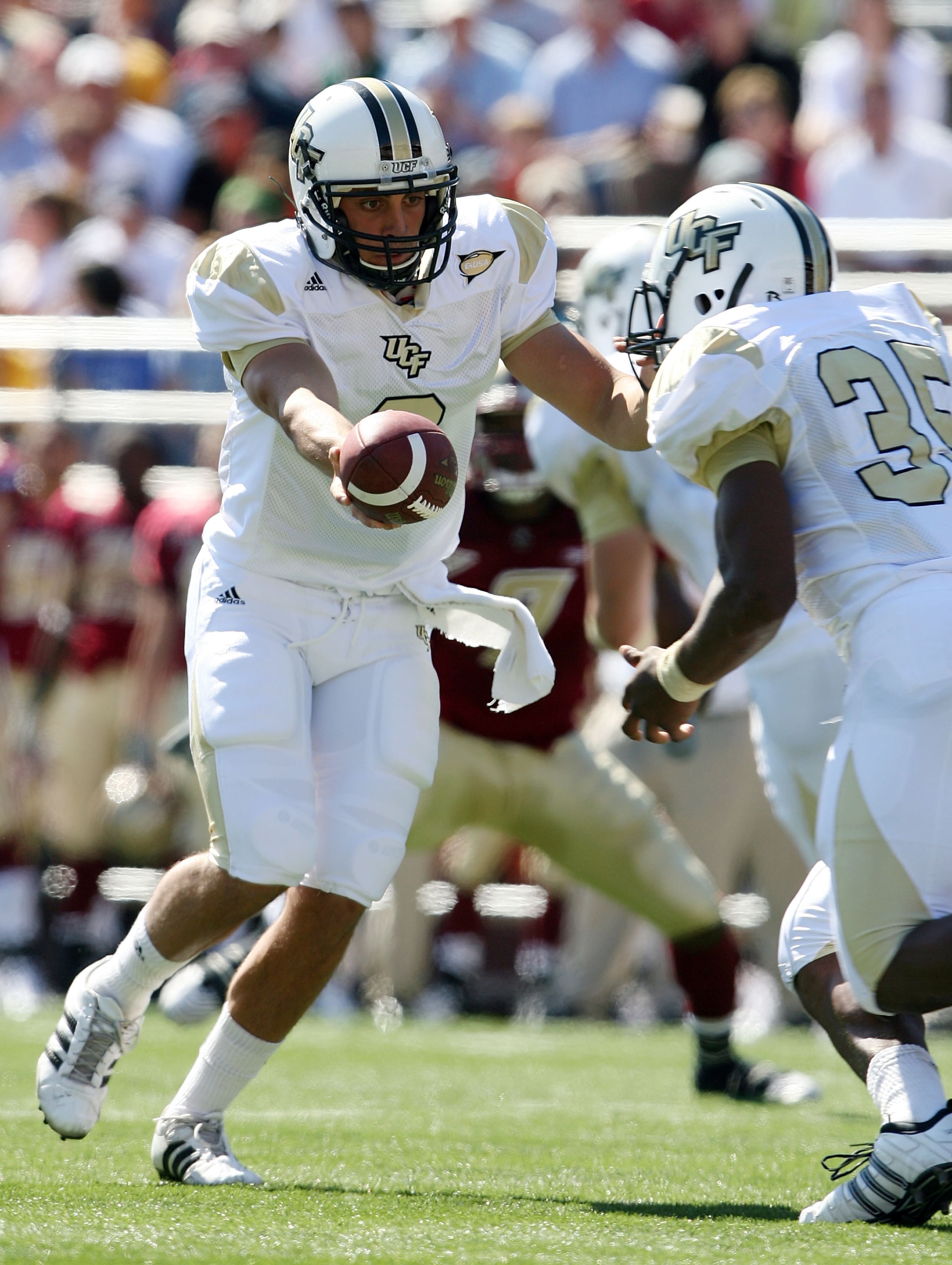 CHESTNUT HILL, MA - SEPTEMBER 20:  Michael Greco #2 of the Central Florida Knights hands the ball off to Ronnie Weaver #35 in the first half against the Boston College Eagles on September 20, 2008 at Alumni Stadium in Chestnut Hill, Massachusetts.  (Photo