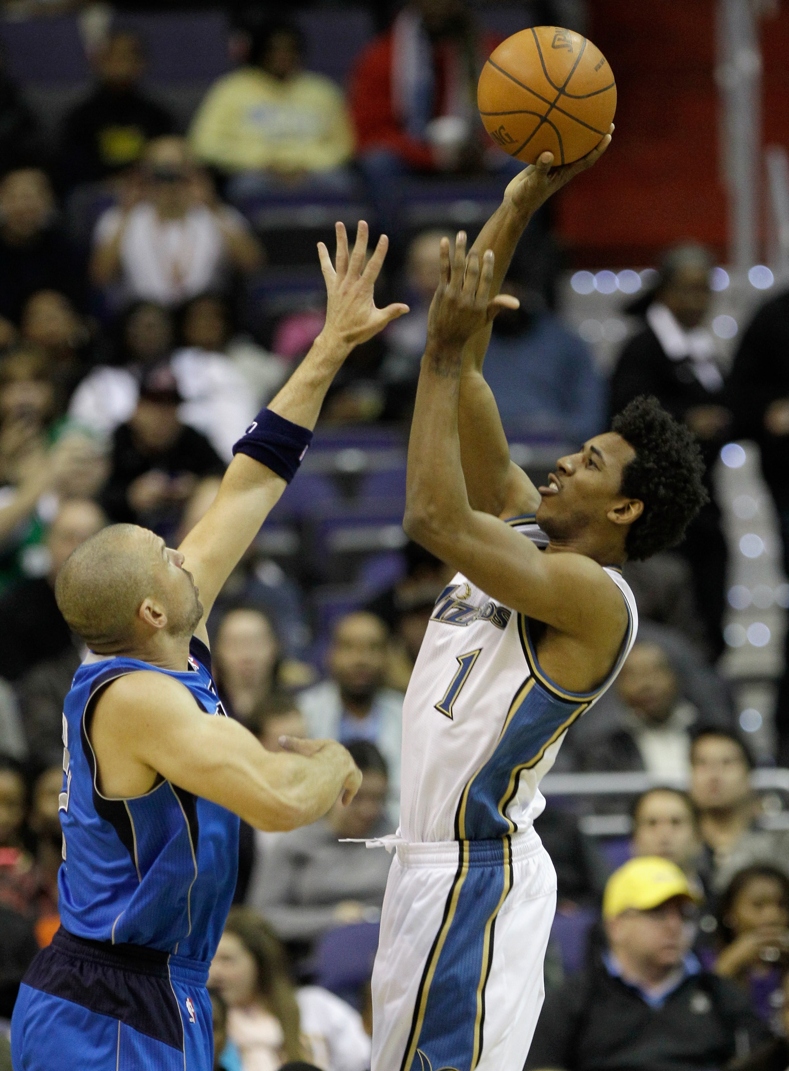 WASHINGTON, DC - FEBRUARY 26: Nick Young #1 of the Washington Wizards shoots over Jason Kidd #2 of the Dallas Mavericks at the Verizon Center on February 26, 2011 in Washington, DC. NOTE TO USER: User expressly acknowledges and agrees that, by downloading