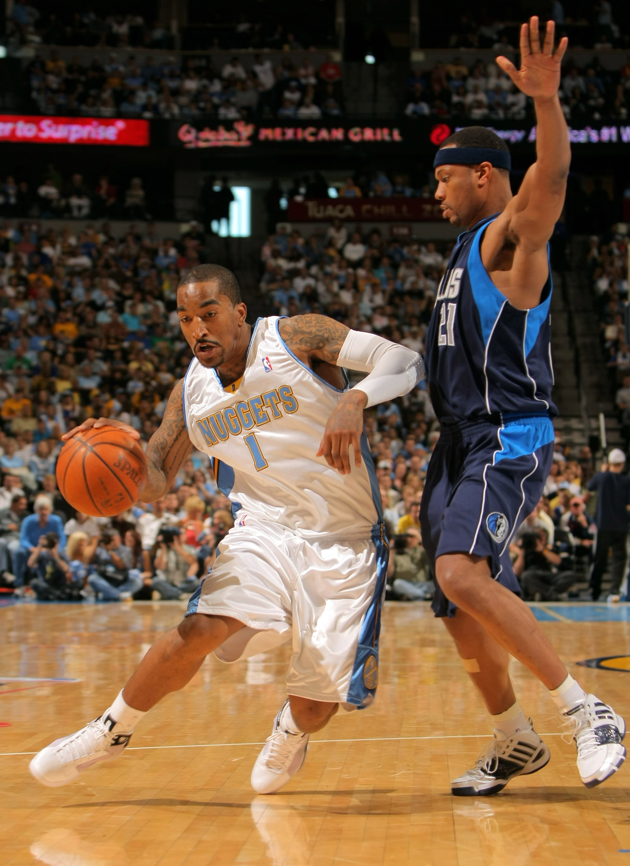 DENVER - MAY 03:  J.R. Smith #1 of the Denver Nuggets drives around Antoine Wright #21 of the Dallas Mavericks in Game One of the Western Conference Semifinals during the 2009 NBA Playoffs at Pepsi Center on May 3, 2009 in Denver, Colorado. NOTE TO USER: 