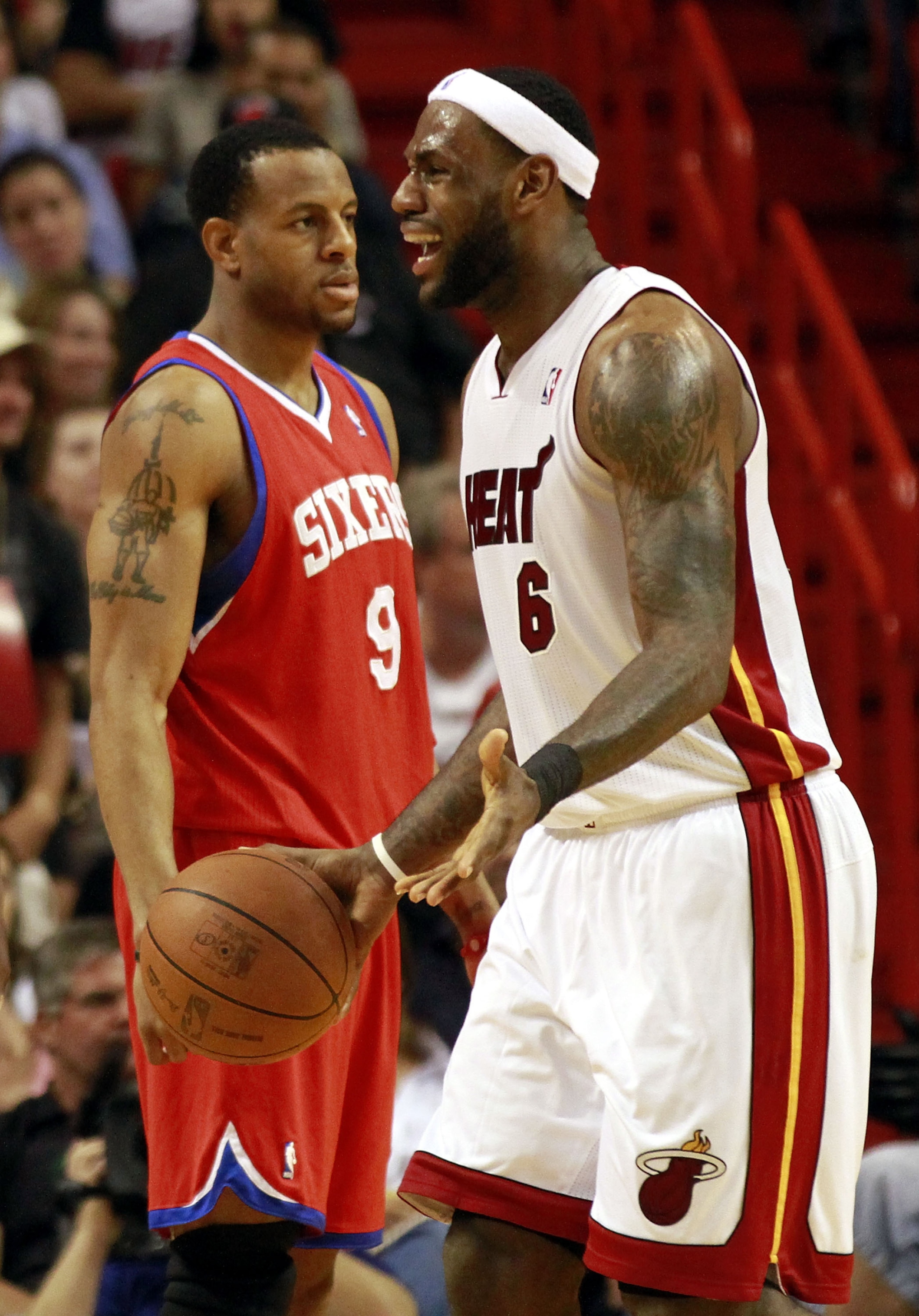 MIAMI, FL - MARCH 25:  LeBron James #6 of the Miami Heat reacts against Guard Andre Iguodala #9 of the Philadelphia Sixers at American Airlines Arena on March 25, 2011 in Miami, Florida. NOTE TO USER: User expressly acknowledges and agrees that, by downlo