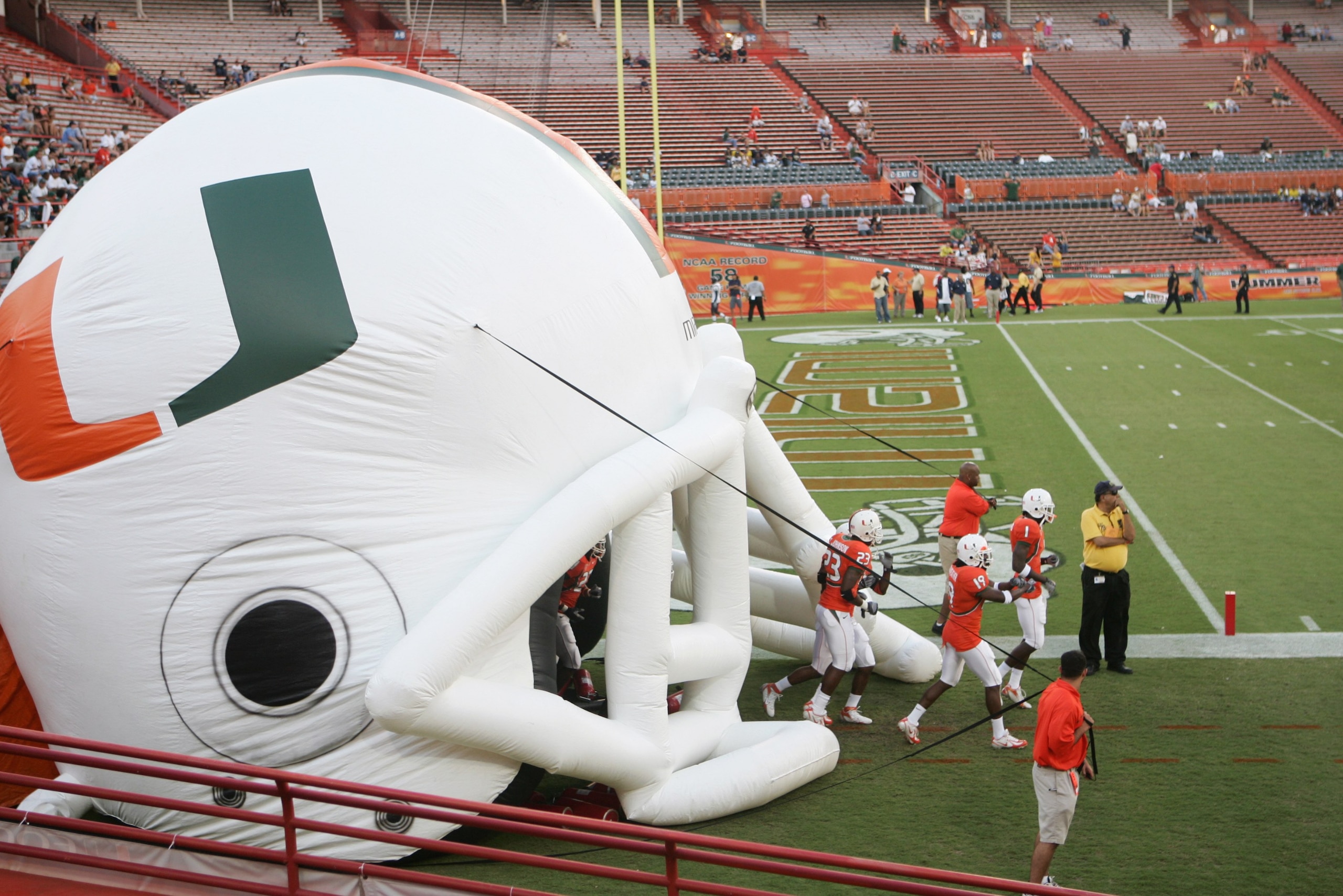 MIAMI - OCTOBER 14:  Miami Hurricanes players enter the field through a giant inflatable helmet before the game against the Florida International Panthers at the Orange Bowl on October 14, 2006 in Miami, Florida. Miami won 35-0.  (Photo by Marc Serota/Get