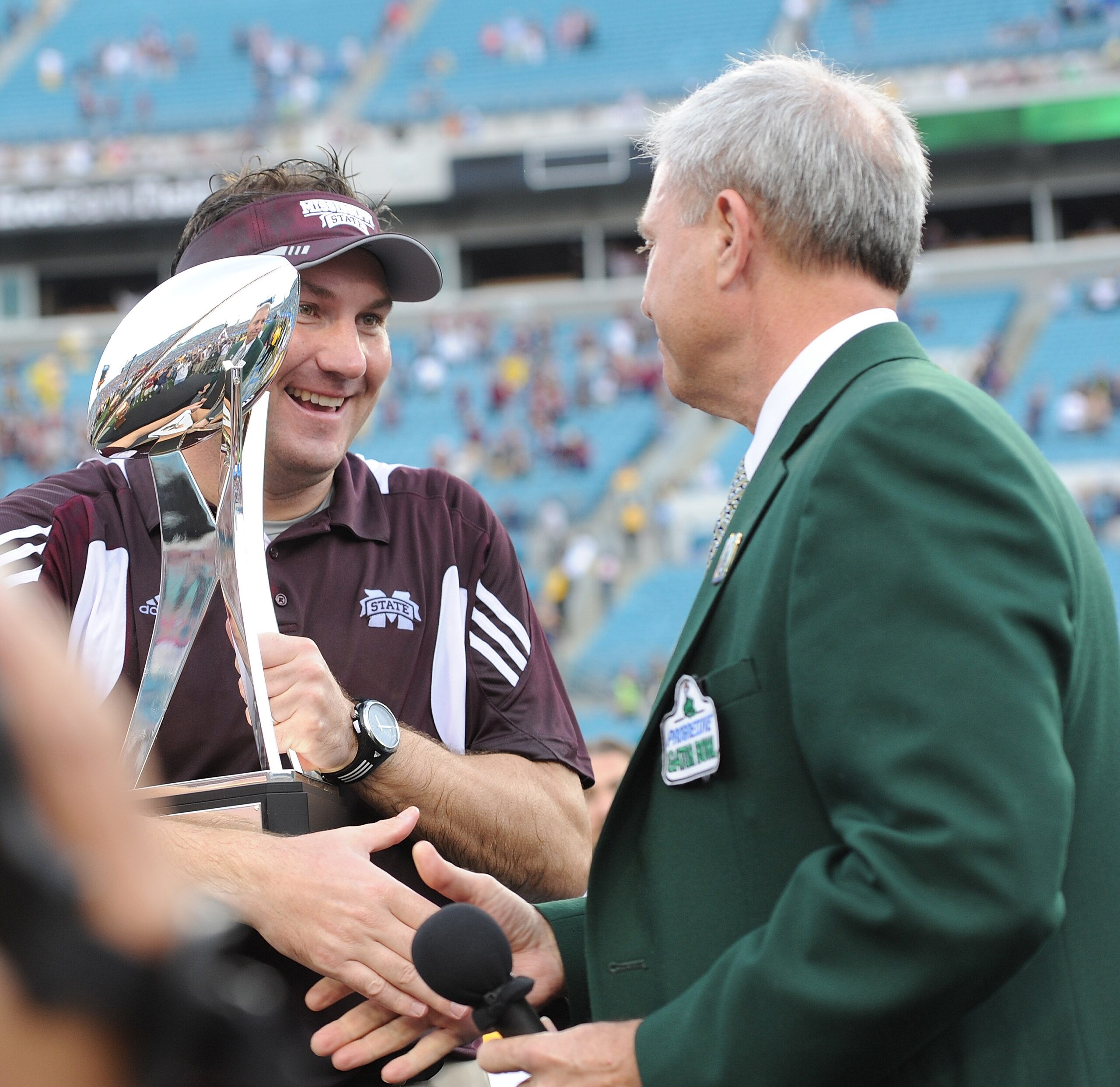 JACKSONVILLE, FL - JANUARY 01:  Dan Mullen accepts the Gator Bowl trophy following his Mississippi State Bulldogs victory over the Michigan Wolverines during the Gator Bowl at EverBank Field on January 1, 2011 in Jacksonville, Florida  (Photo by Rick Dole