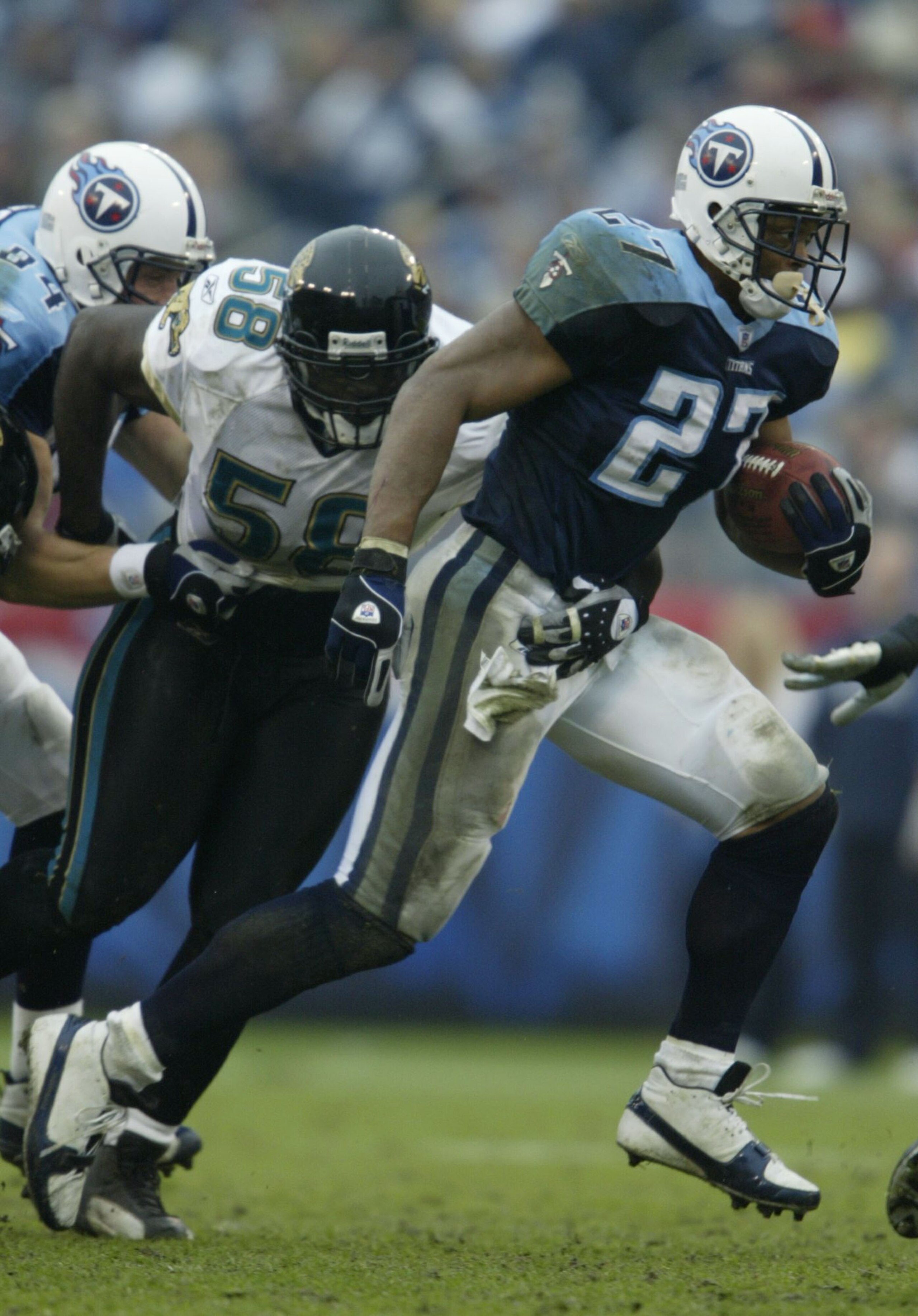 NASHVILLE, TN - NOVEMBER 16: Eddie George #27 of the Tennessee Titans runs past Hugh Douglas #58 of the Jacksonville Jaguars on November 16, 2003 at The Coliseum in Nashville, Tennessee. The Titans won 10-3. (Photo by Elsa/Getty Images) NASHVILLE, TN - NOVEMBER 16: Eddie George #27 of the Tennessee Titans runs past Hugh Douglas #58 of the Jacksonville Jaguars on November 16, 2003 at The Coliseum in Nashville, Tennessee. The Titans won 10-3. (Photo by Elsa/Getty Images)