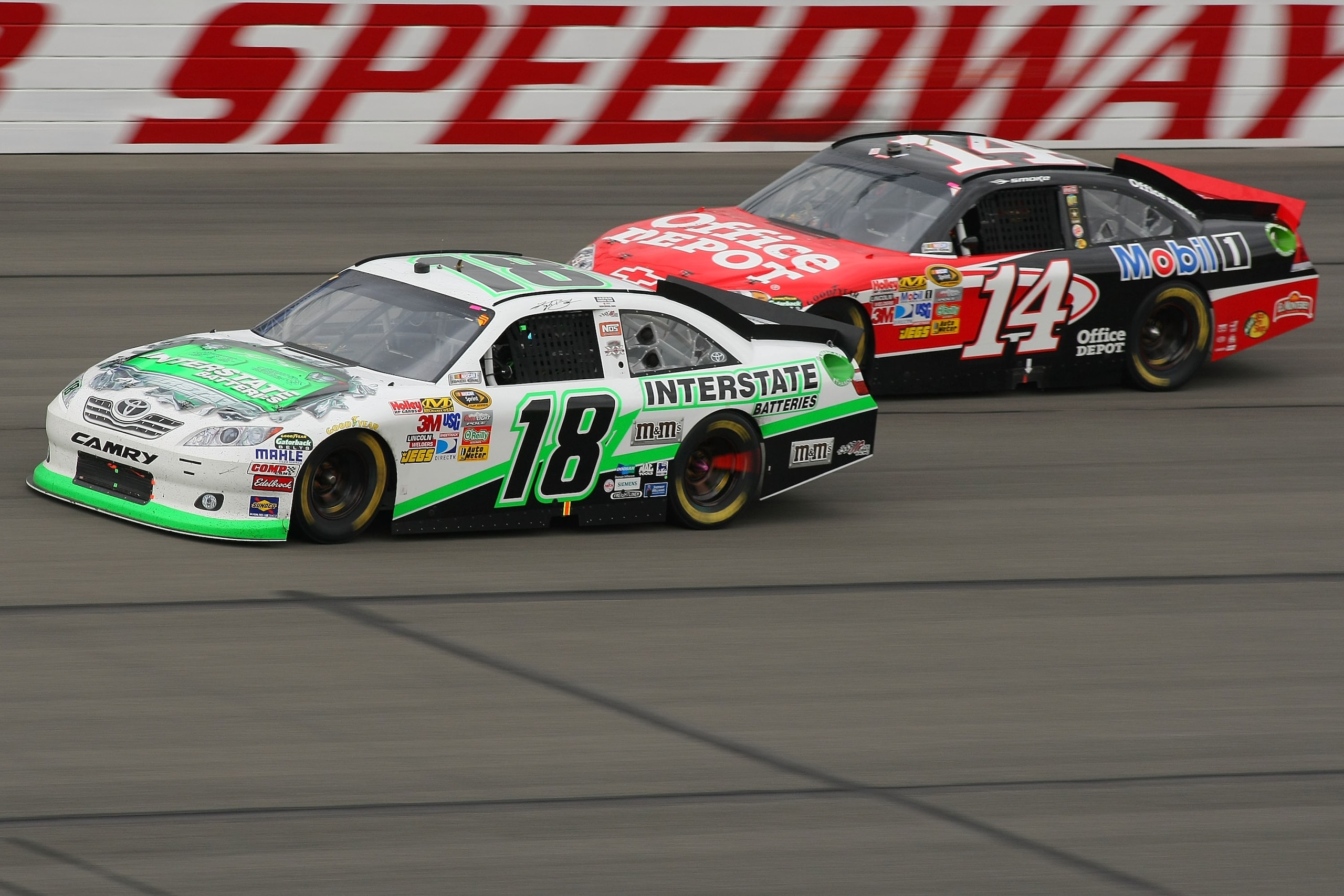 FONTANA, CA - MARCH 27: Kyle Busch, driver of the #18 Interstate Batteries Toyota, and Tony Stewart, driver of the #14 Office Depot Toyota, drive during the NASCAR Sprint Cup Series Auto Club 400 at Auto Club Speedway on March 27, 2011 in Fontana, Califo FONTANA, CA - MARCH 27: Kyle Busch, driver of the #18 Interstate Batteries Toyota, and Tony Stewart, driver of the #14 Office Depot Toyota, drive during the NASCAR Sprint Cup Series Auto Club 400 at Auto Club Speedway on March 27, 2011 in Fontana, Califo