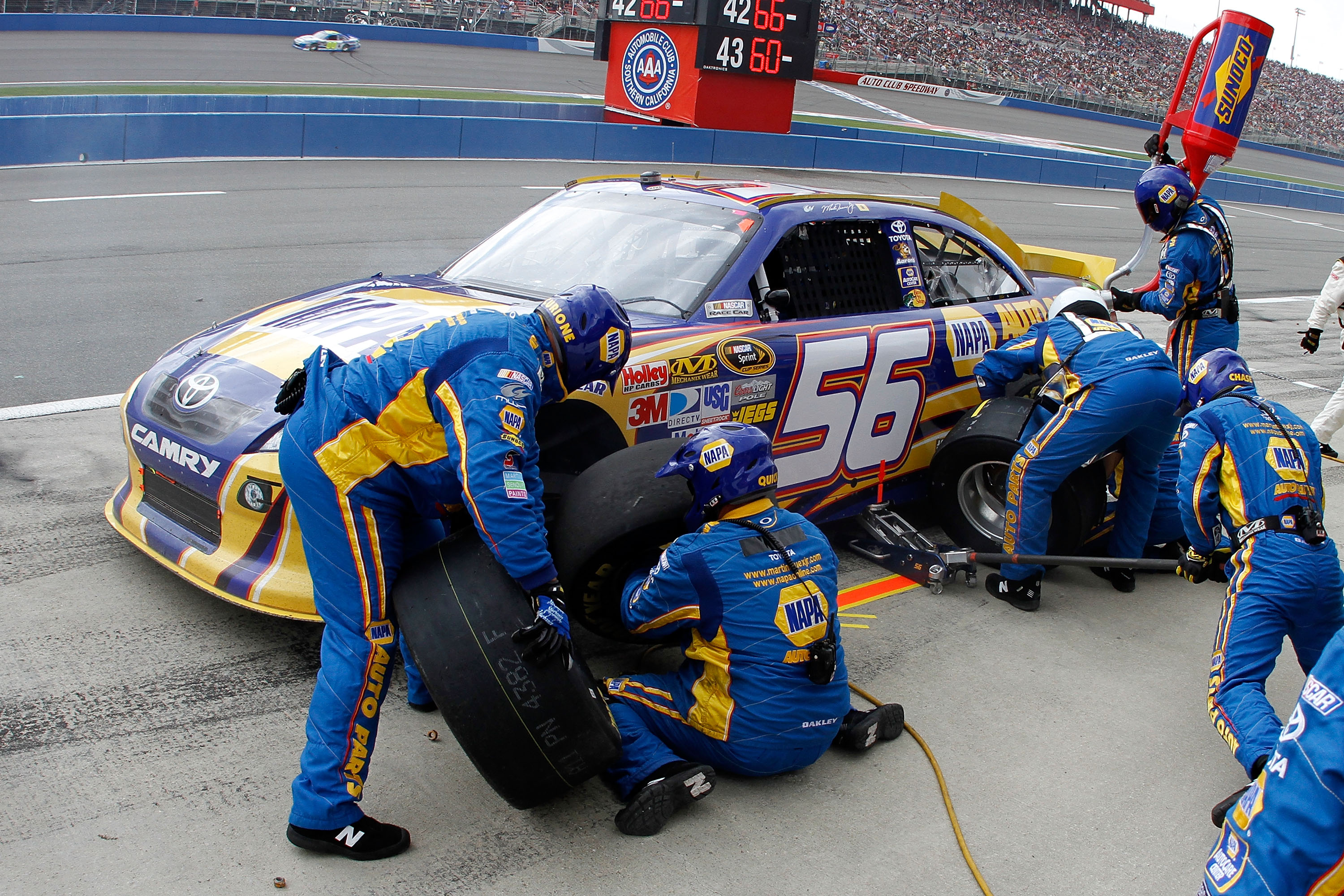 FONTANA, CA - MARCH 27:  Martin Truex Jr., driver of the #56 NAPA Toyota, makes a pit stop during the NASCAR Sprint Cup Series Auto Club 400 at Auto Club Speedway on March 27, 2011 in Fontana, California.  (Photo by Jason Smith/Getty Images for NASCAR)