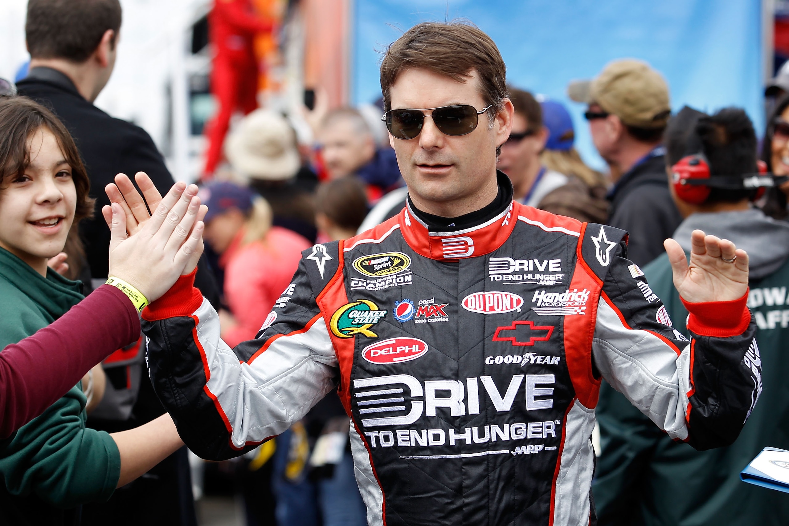 FONTANA, CA - MARCH 27: Jeff Gordon, driver of the #24 Drive to End Hunger Chevrolet, greets fans during driver introductions for the NASCAR Sprint Cup Series Auto Club 400 at Auto Club Speedway on March 27, 2011 in Fontana, California. (Photo by Todd W FONTANA, CA - MARCH 27: Jeff Gordon, driver of the #24 Drive to End Hunger Chevrolet, greets fans during driver introductions for the NASCAR Sprint Cup Series Auto Club 400 at Auto Club Speedway on March 27, 2011 in Fontana, California. (Photo by Todd W