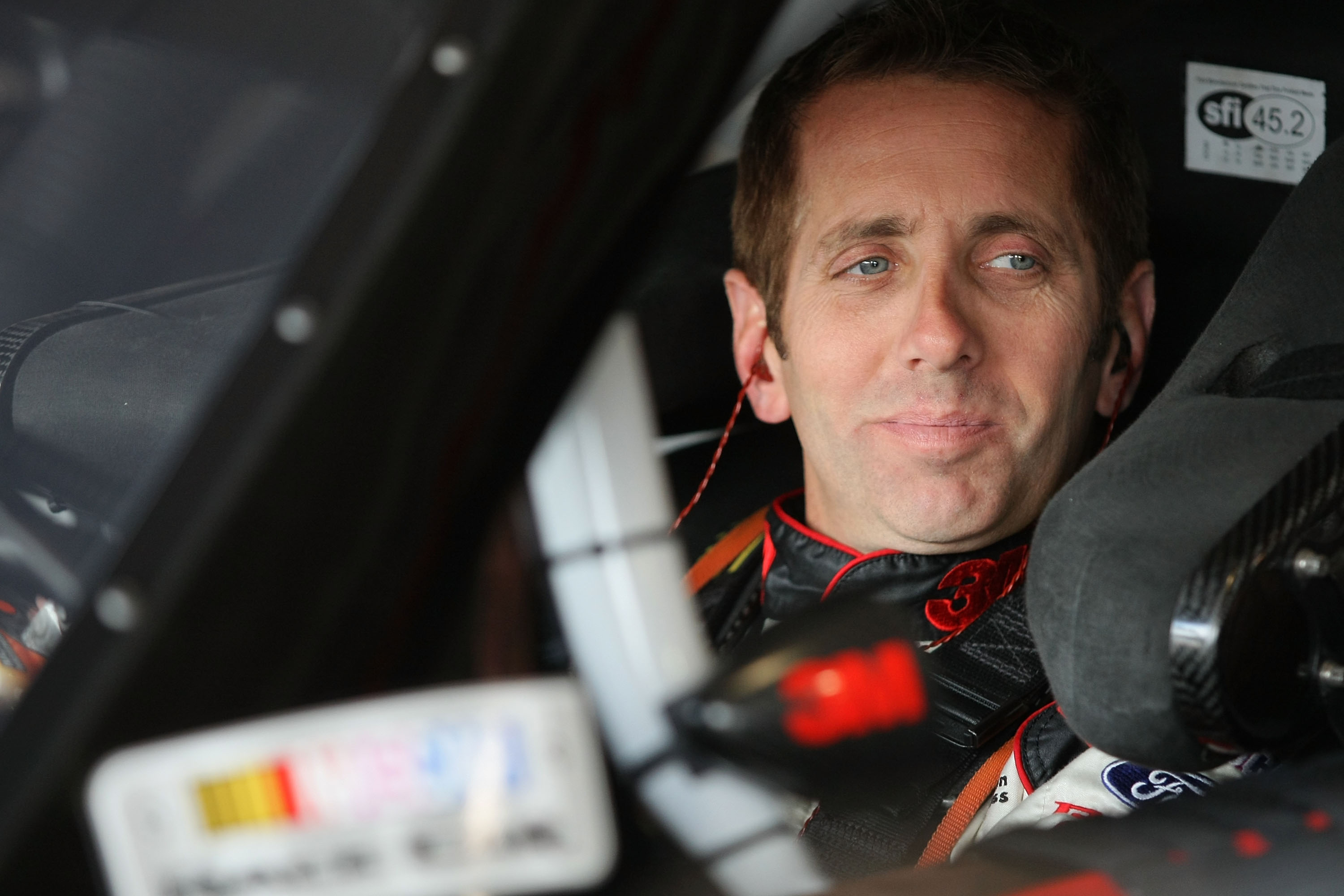 FONTANA, CA - MARCH 25:  Greg Biffle, driver of the #16 3M Ford, sits in his car during practice for the NASCAR Sprint Cup Series Auto Club 400 at Auto Club Speedway on March 25, 2011 in Fontana, California.  (Photo by Victor Decolongon/Getty Images for N