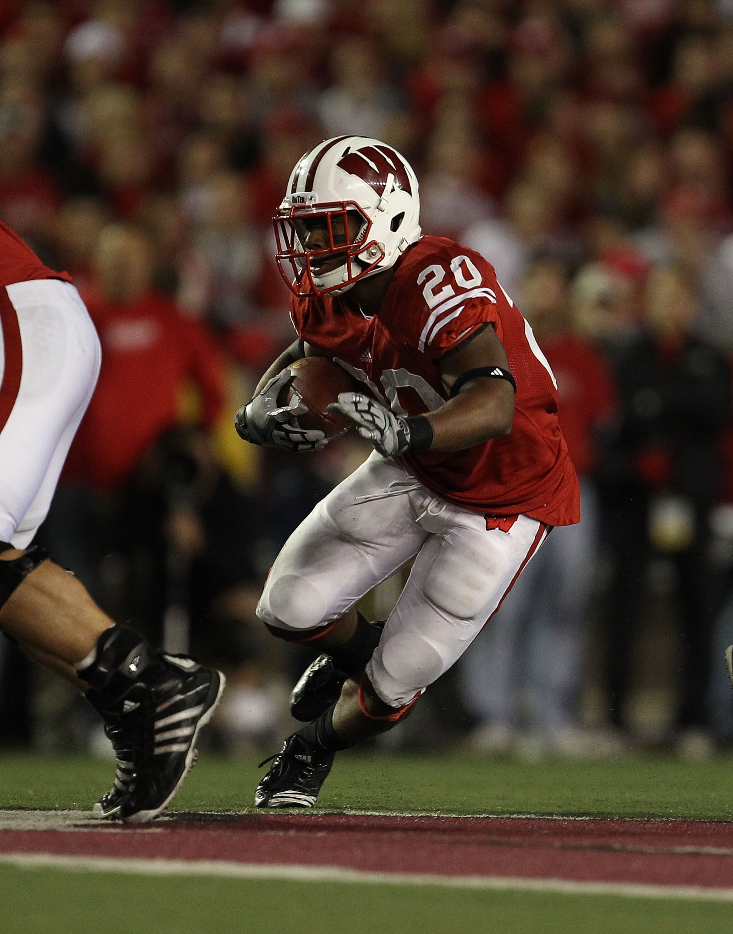 MADISON, WI - OCTOBER 16: James White #20 of the Wisconsin Badgers runs against the Ohio State Buckeyes at Camp Randall Stadium on October 16, 2010 in Madison, Wisconsin. Wisconsin defeated Ohio State 31-18. (Photo by Jonathan Daniel/Getty Images)