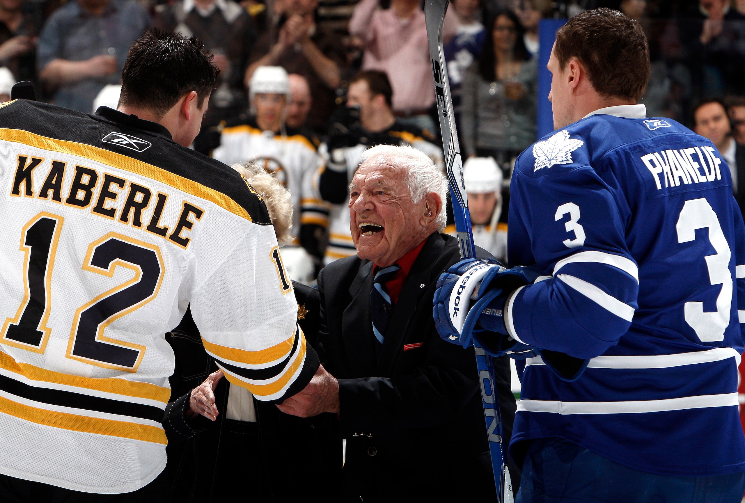 TORONTO, CANADA - MARCH 19: Howie Meeker shakes Tomas Kaberle #12 of the Boston Bruins' hand  with Dion Phaneuf #3 of the Toronto Maple Leafs before game action at the Air Canada Centre March 19, 2011 in Toronto, Ontario, Canada. (Photo by Abelimages/Gett