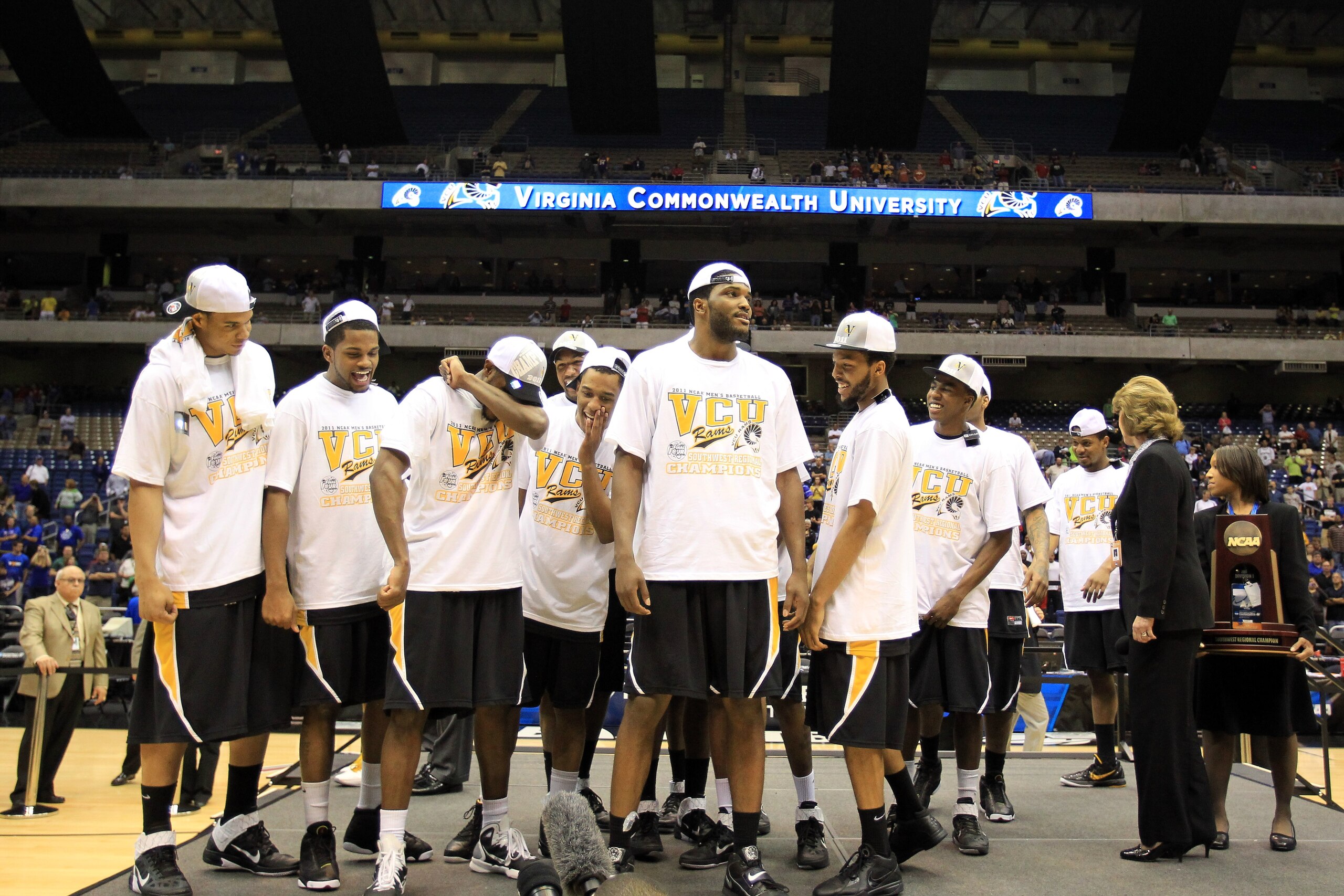 SAN ANTONIO, TX - MARCH 27:  The Virginia Commonwealth Rams celebrate on the stage after defeating the Kansas Jayhawks during the southwest regional final of the 2011 NCAA men's basketball tournament at the Alamodome on March 27, 2011 in San Antonio, Texa