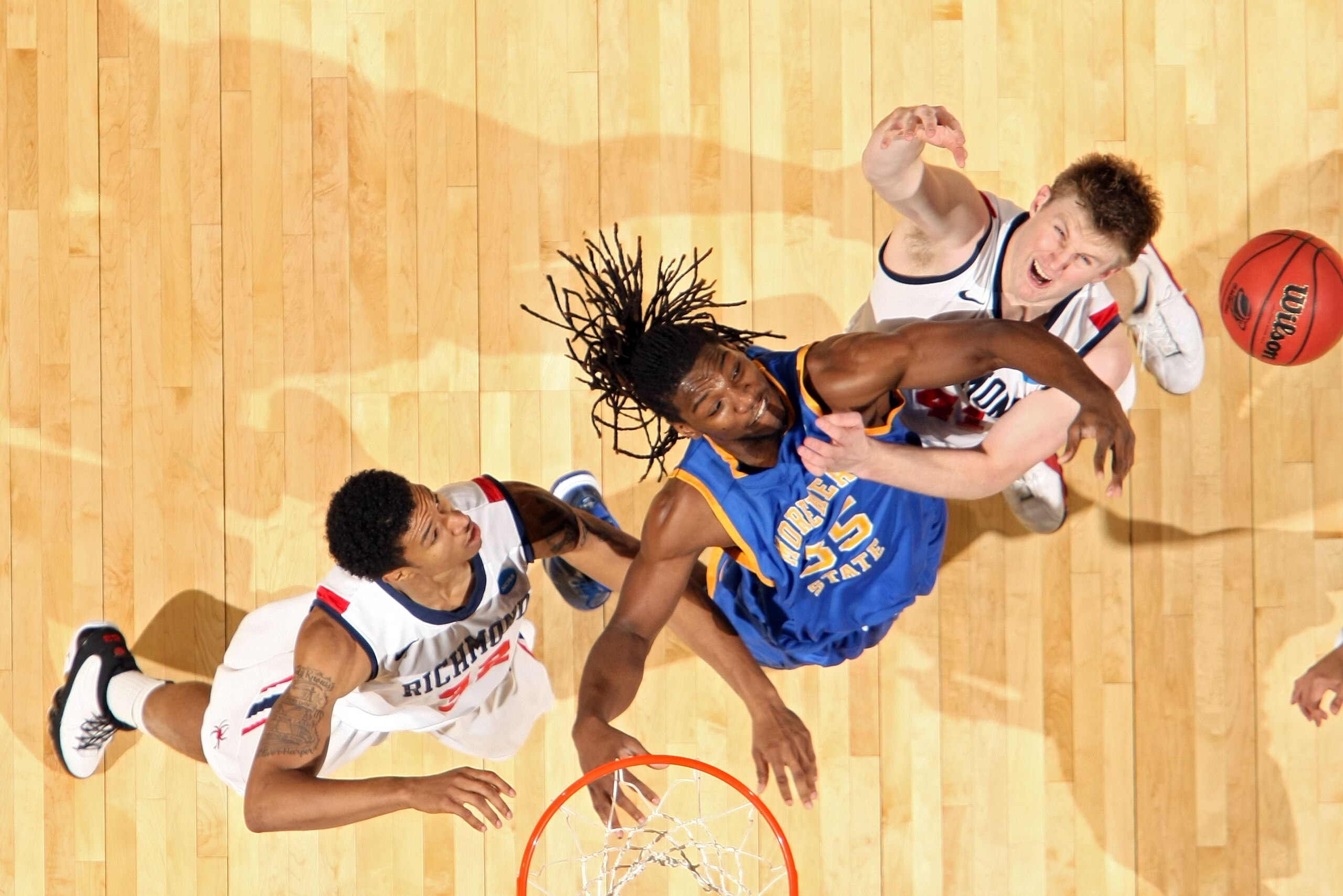 DENVER, CO - MARCH 19:  Kenneth Faried #35 of the Morehead State Eagles fights for a loose ball against Justin Harper #32 and Dan Geriot #41 of the Richmond Spiders during the third round of the 2011 NCAA men's basketball tournament at Pepsi Center on Mar