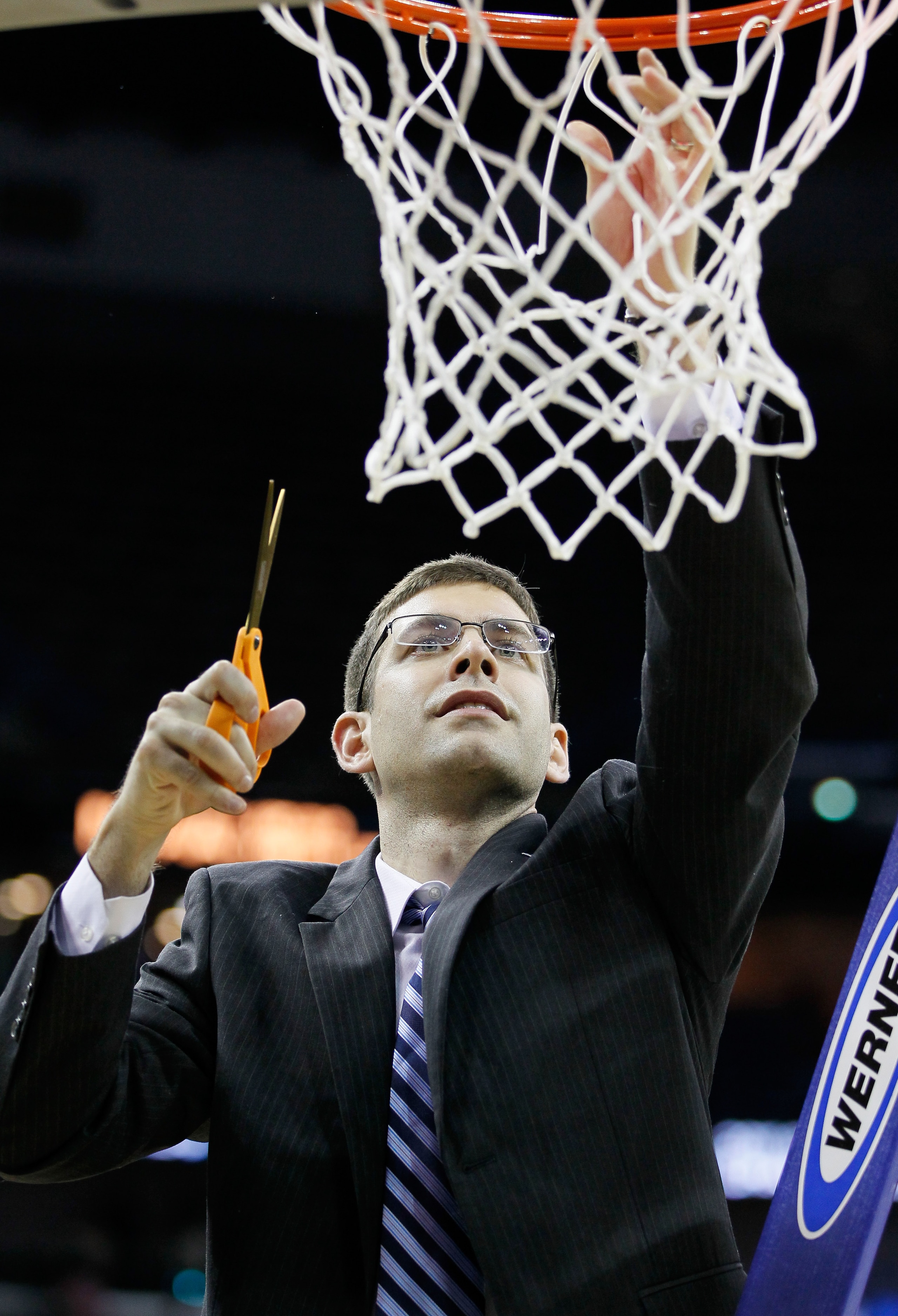 NEW ORLEANS, LA - MARCH 26:  Head coach Brad Stevens of the Butler Bulldogs celebrates defeateing the Florida Gators 74 to 71 in overtime by cuttin down part of the net during the Southeast regional final of the 2011 NCAA men's basketball tournament at Ne