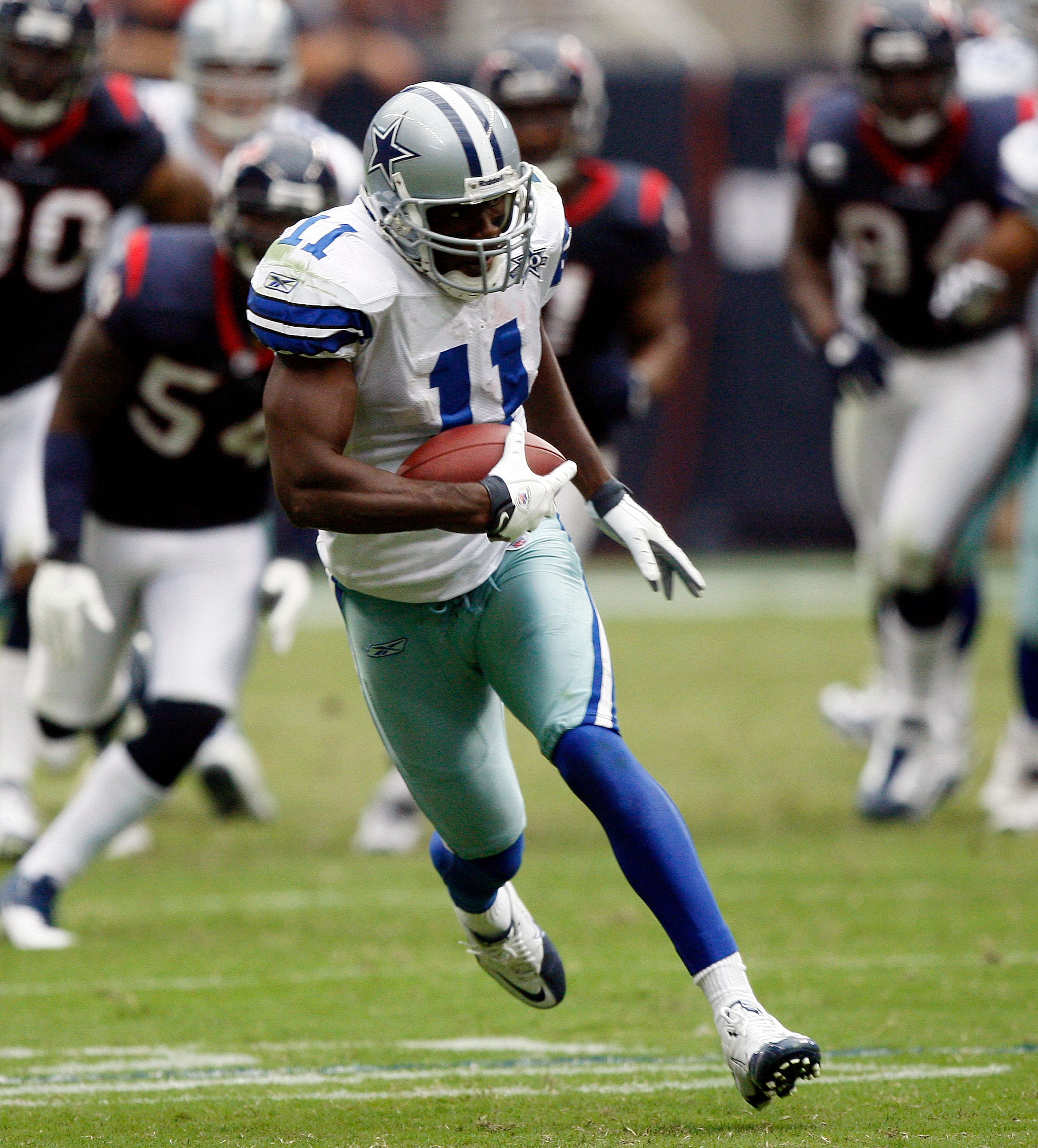 HOUSTON - SEPTEMBER 26:  Wide receiver Roy Williams #11 of the Dallas Cowboys runs for a 63 yard touchdown in the fourth quarter against the Houston Texans at Reliant Stadium on September 26, 2010 in Houston, Texas.  (Photo by Bob Levey/Getty Images)