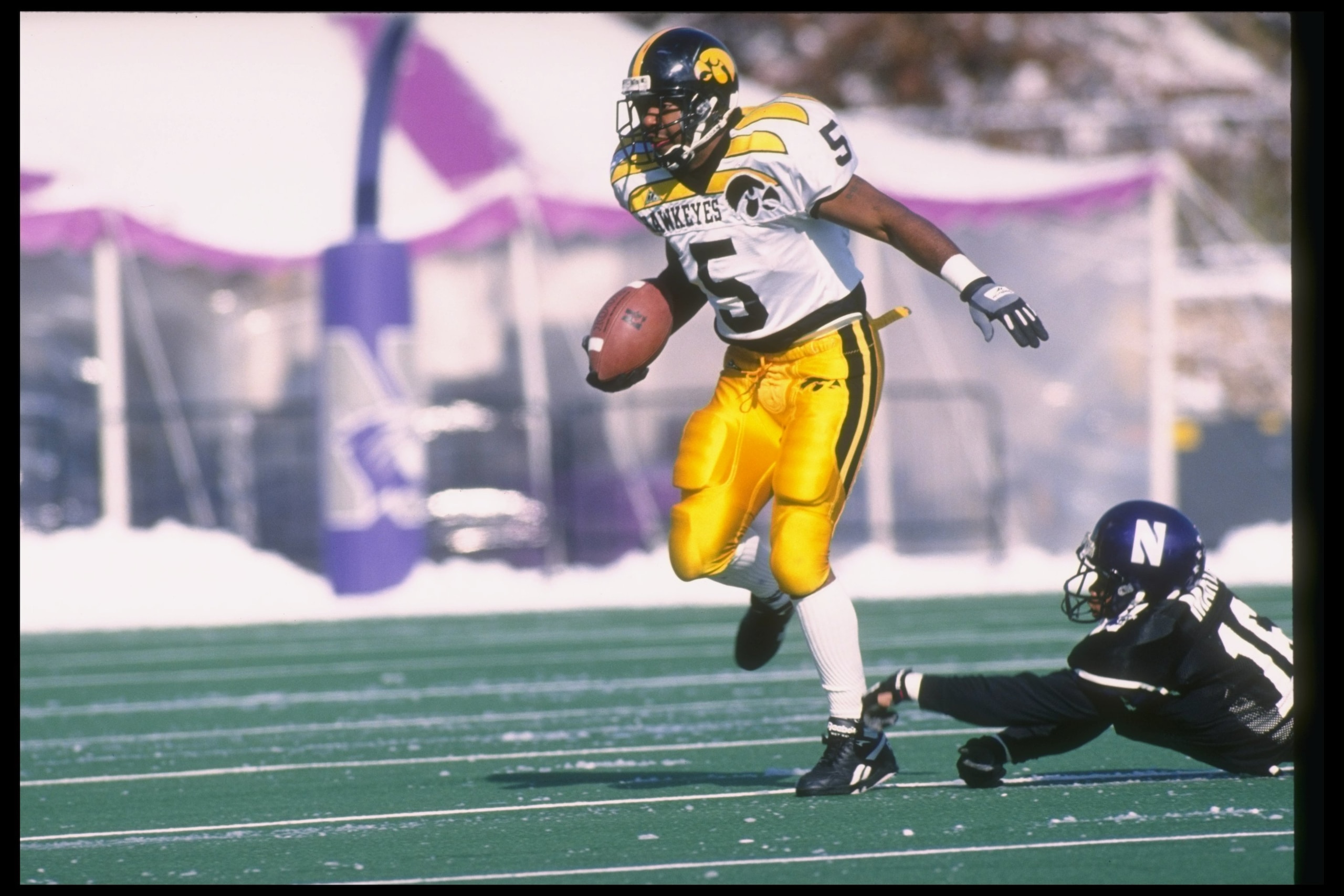 11 Nov 1995:  Running back Sedrick Shaw of the Iowa Hawkeyes (left) breaks the tackle of cornerback Chris Martin of the Northwestern Wildcats during a game at Dyche Stadium in Evanston, Illinois.  Northwestern won the game, 31-20. Mandatory Credit: Jonath