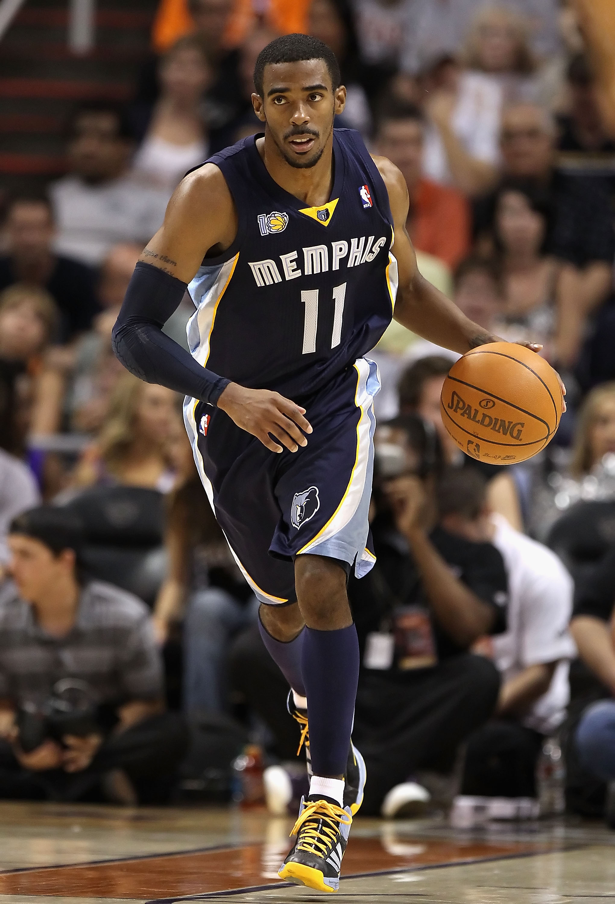 PHOENIX - NOVEMBER 05:  Mike Conley #11 of the Memphis Grizzlies handles the ball during the NBA game against the Phoenix Suns at US Airways Center on November 5, 2010 in Phoenix, Arizona. NOTE TO USER: User expressly acknowledges and agrees that, by down